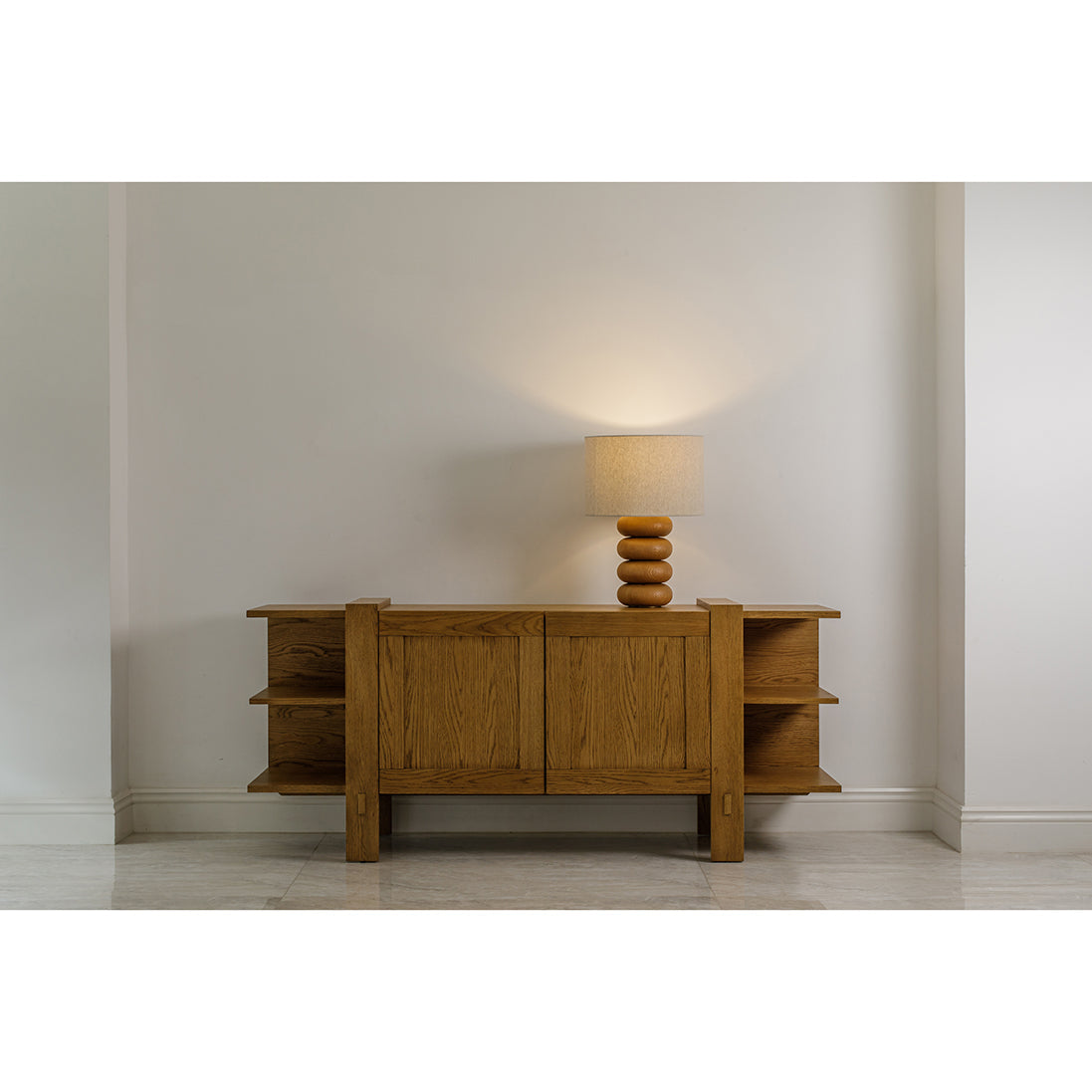 The Solana table lamp sits on a wooden sideboard.