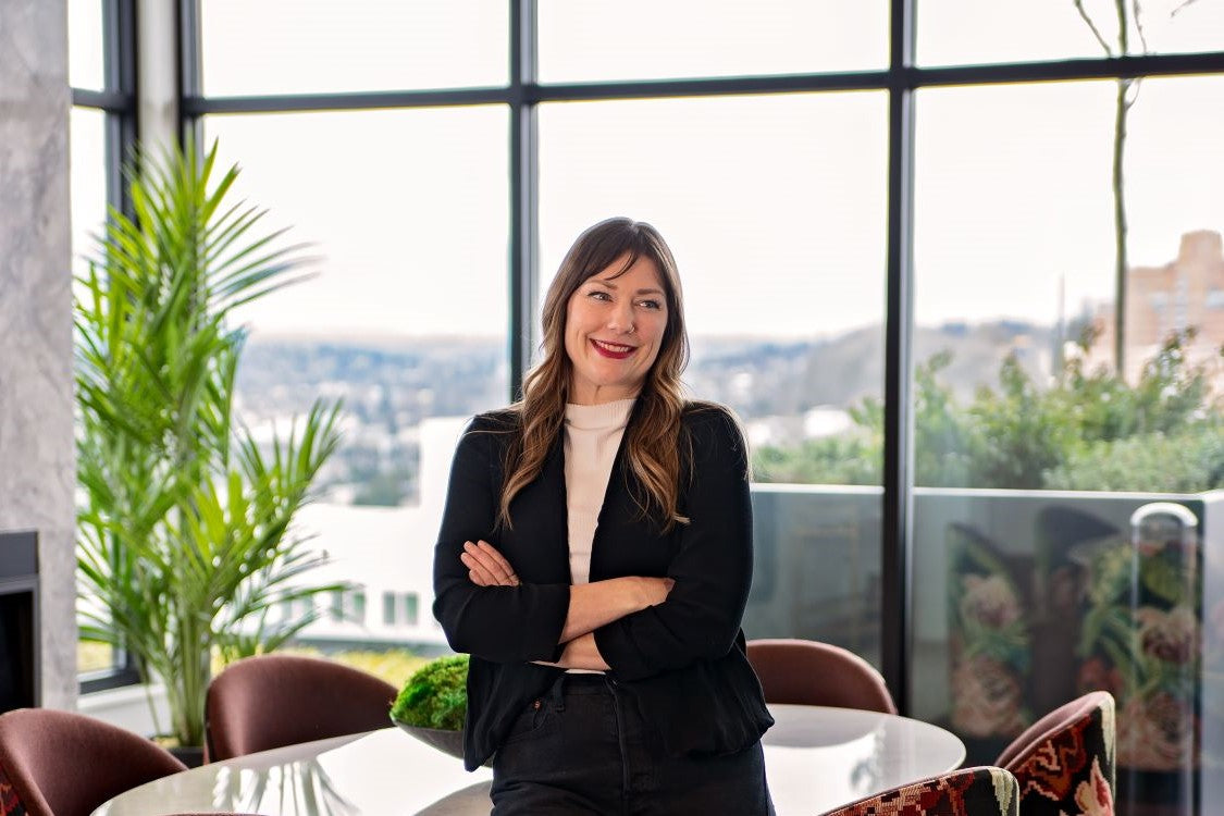 Megan Reay Standing with arms crossed looking to the right