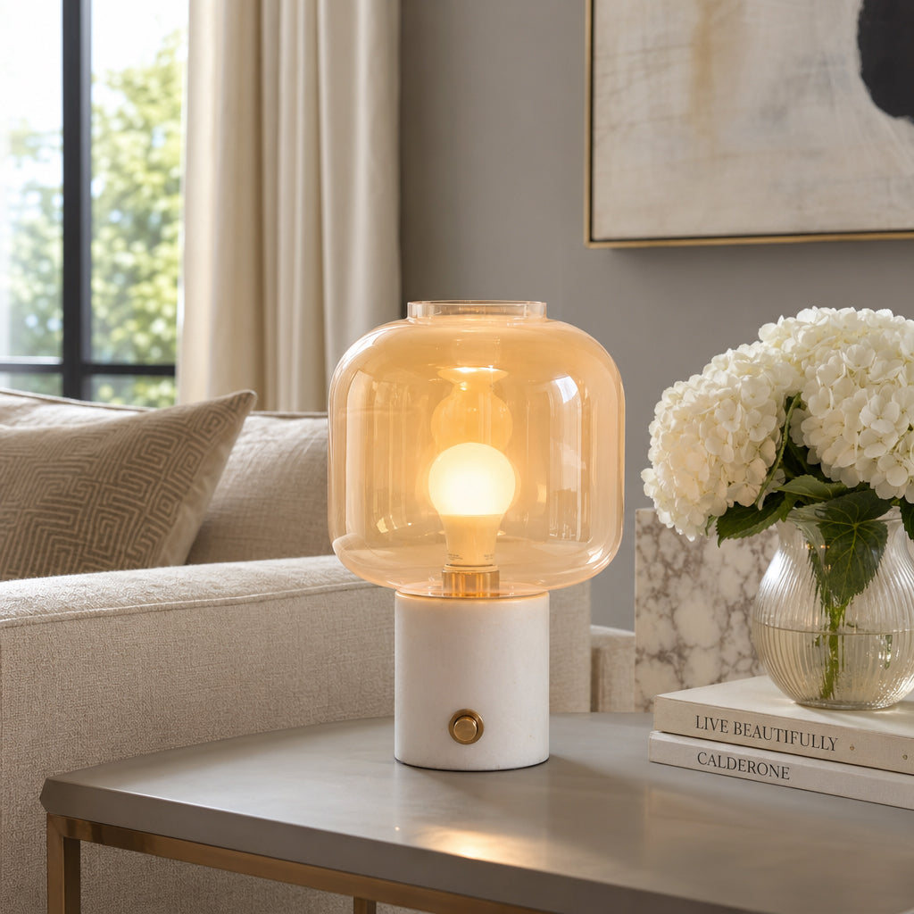 Table lamp with a warm glow on a side table in a living room setting.