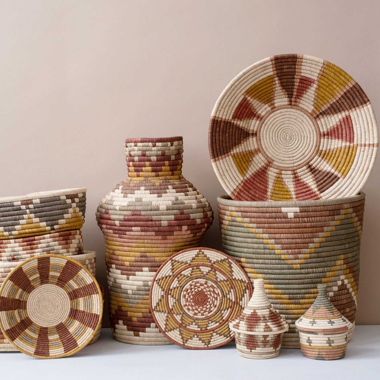 Set of woven baskets and vases with geometric patterns on a neutral background