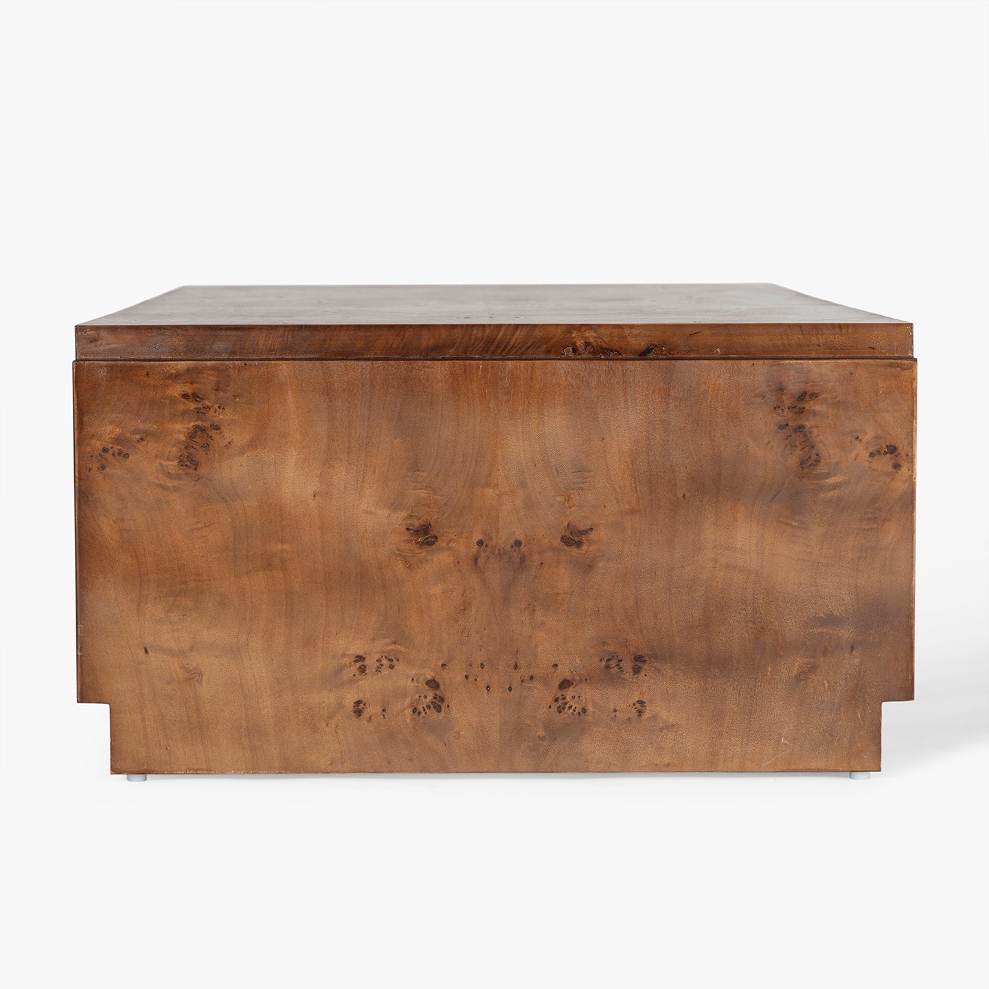 Side view of wooden burl coffee table with a white background