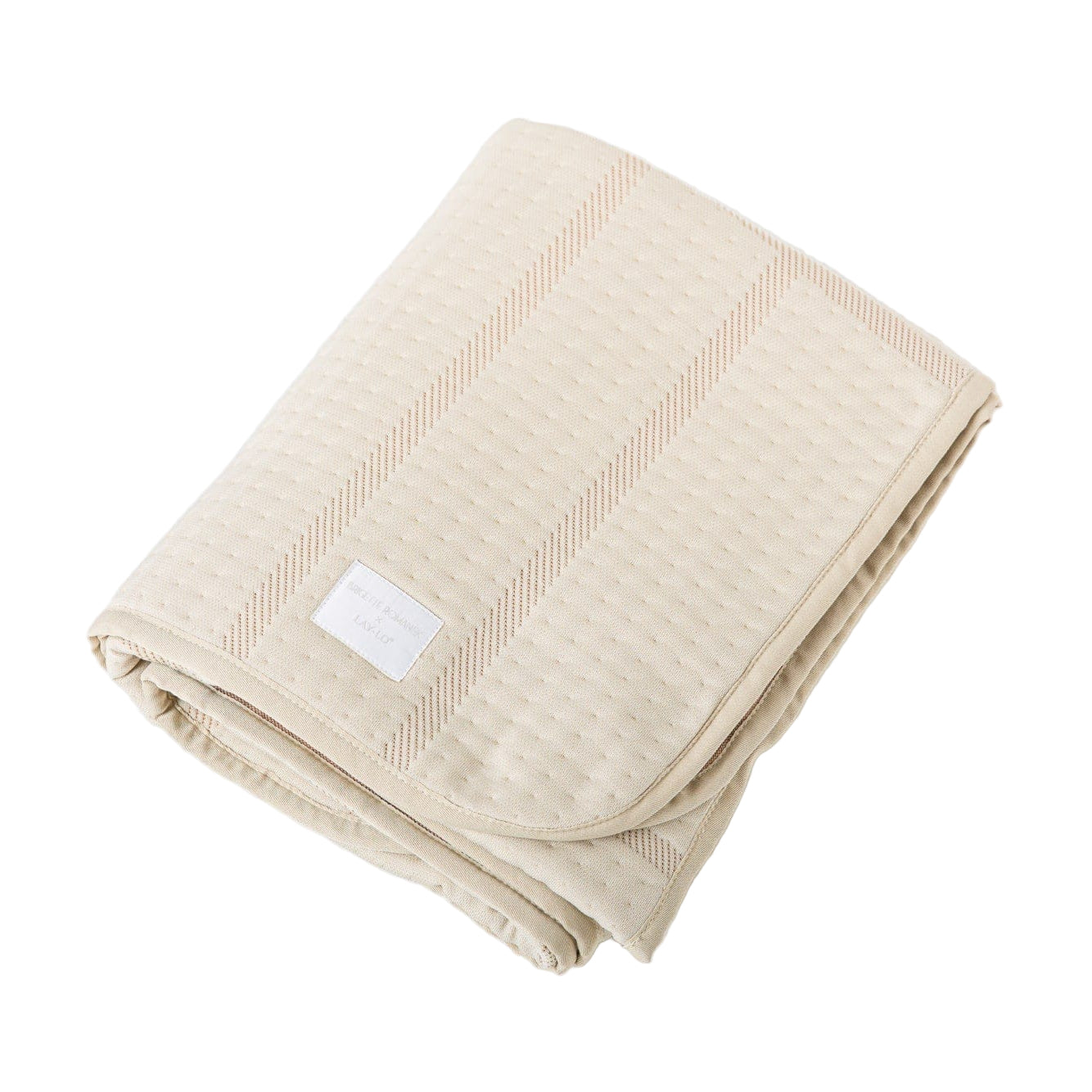 Beige folded dog blanket with a label on a white background