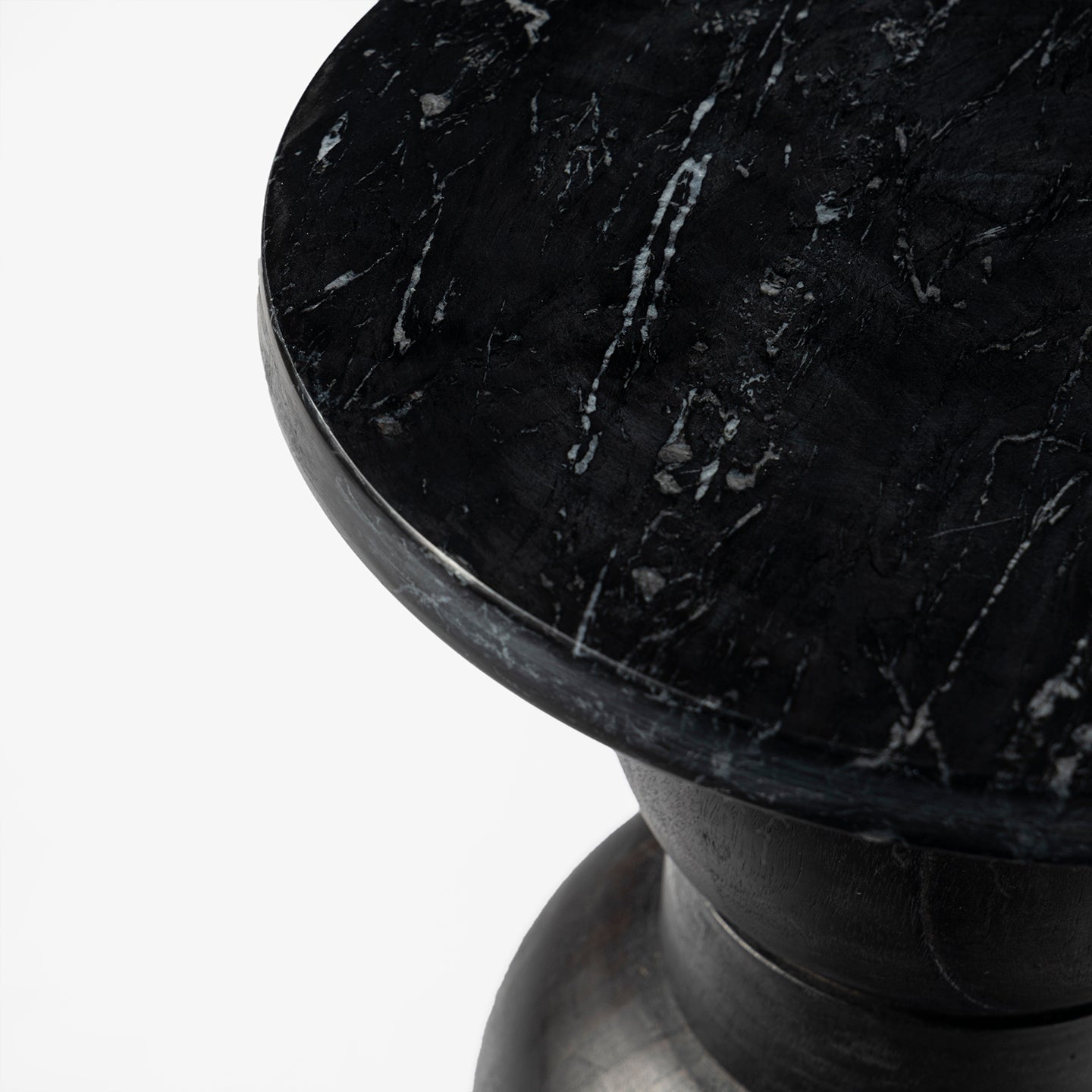 Round black marble table with a white background