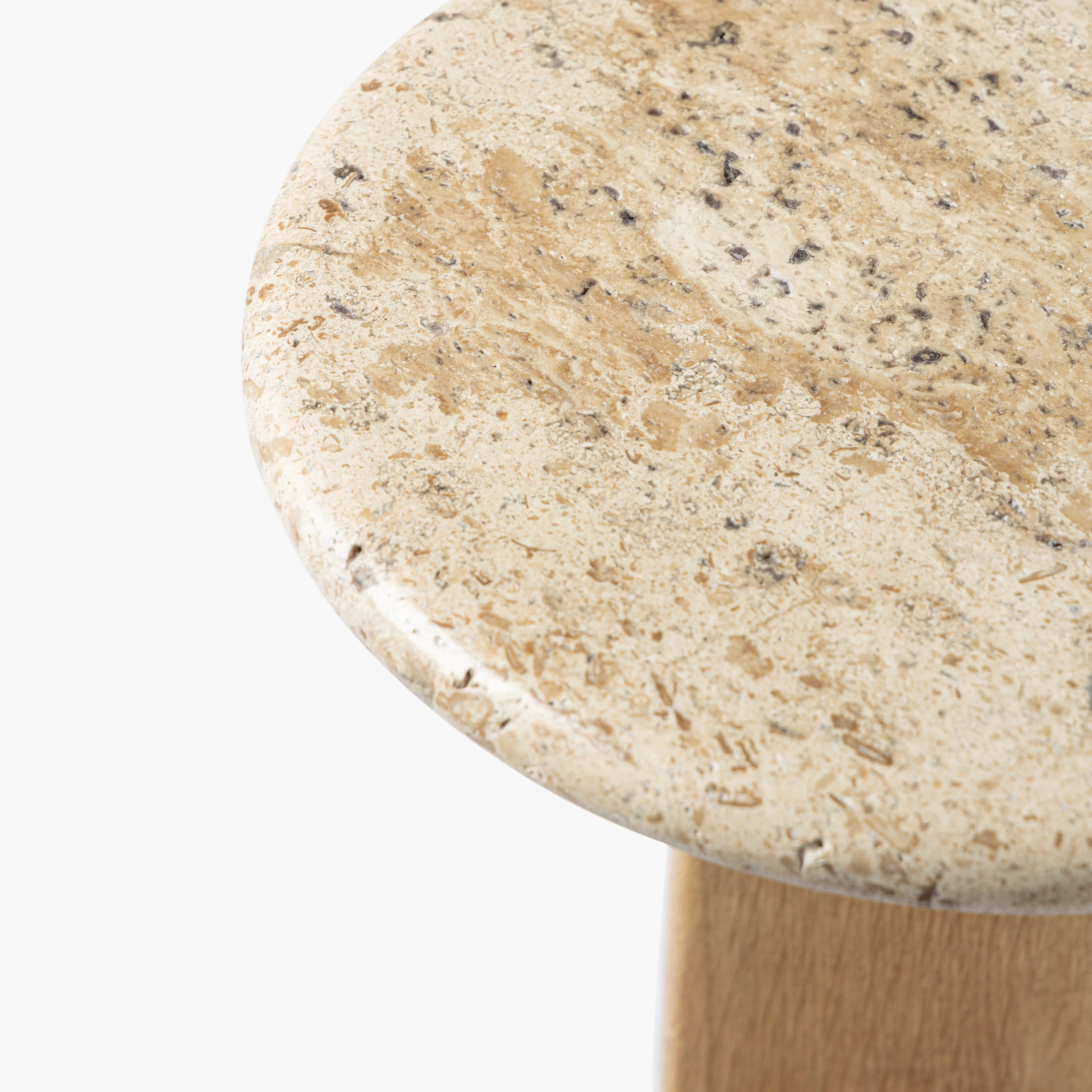 Round stone table top with a beige and brown speckled pattern on a white background