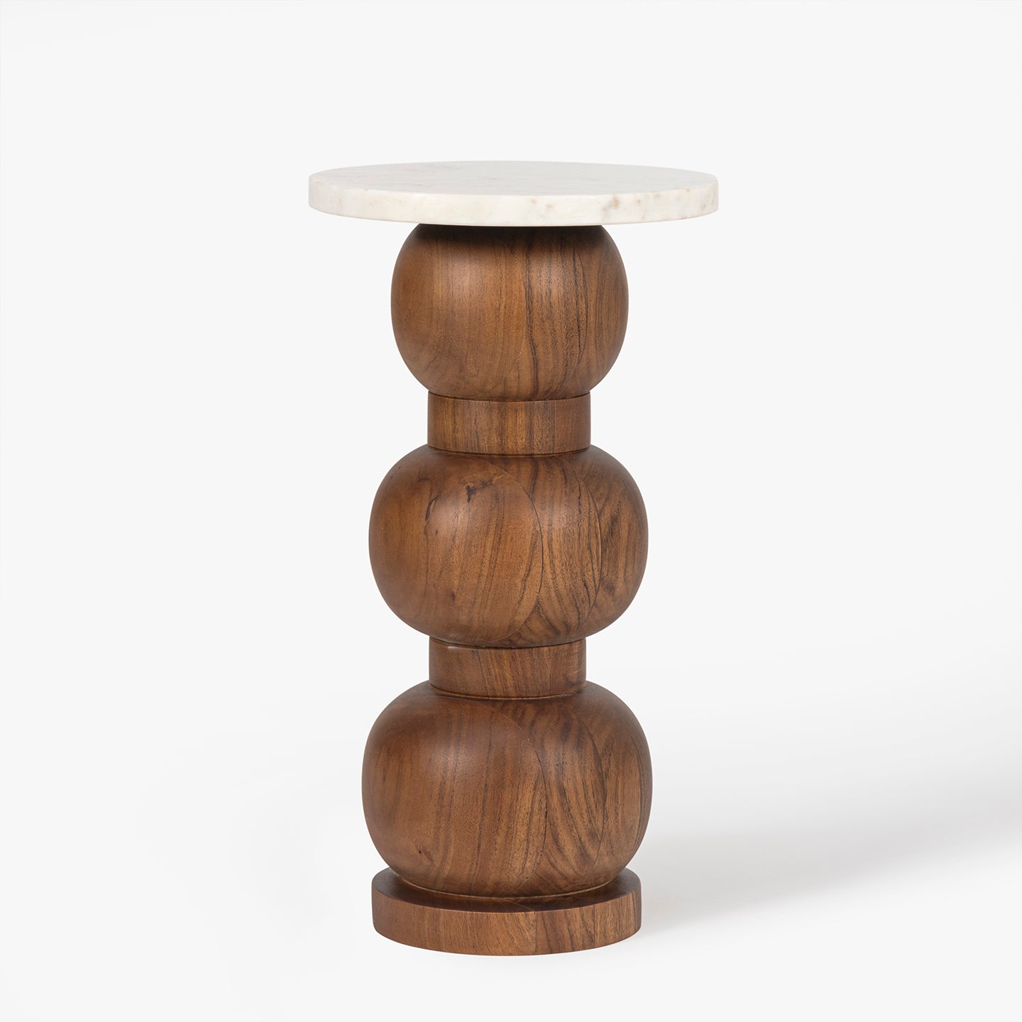 Wooden side table with rounded base details with marble top on a white background