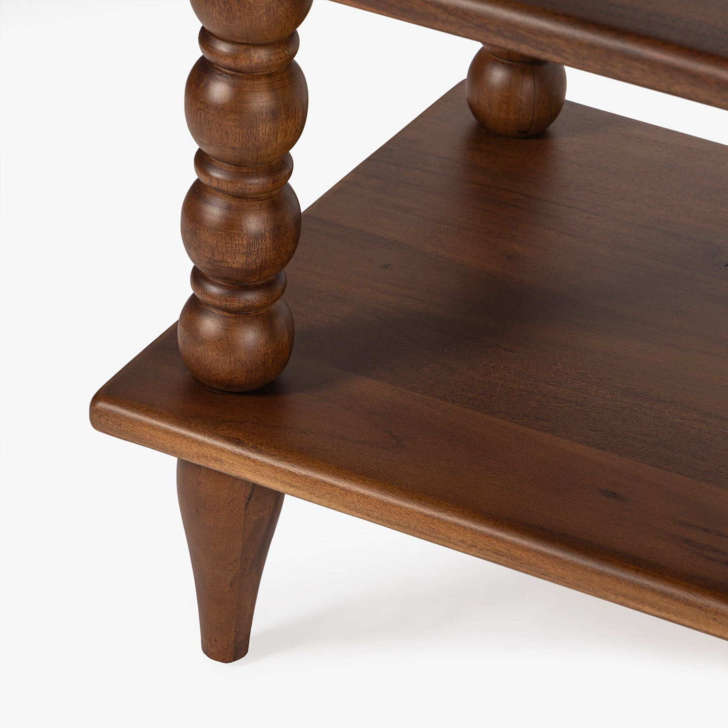 Wooden side table with turned legs on a white background