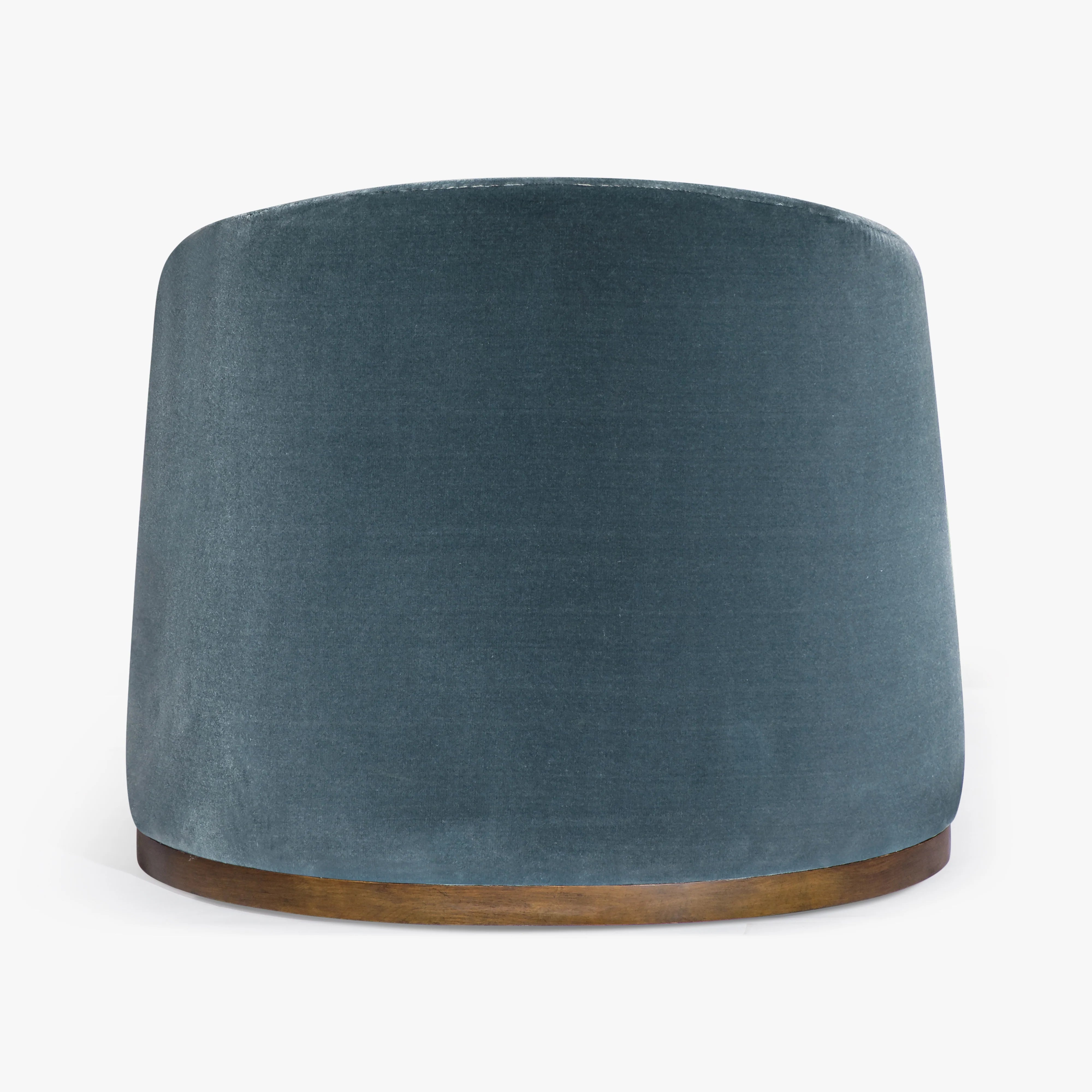 A cylindrical armchair in textured slate blue velvet with a natural wood base, shown against a plain white background.