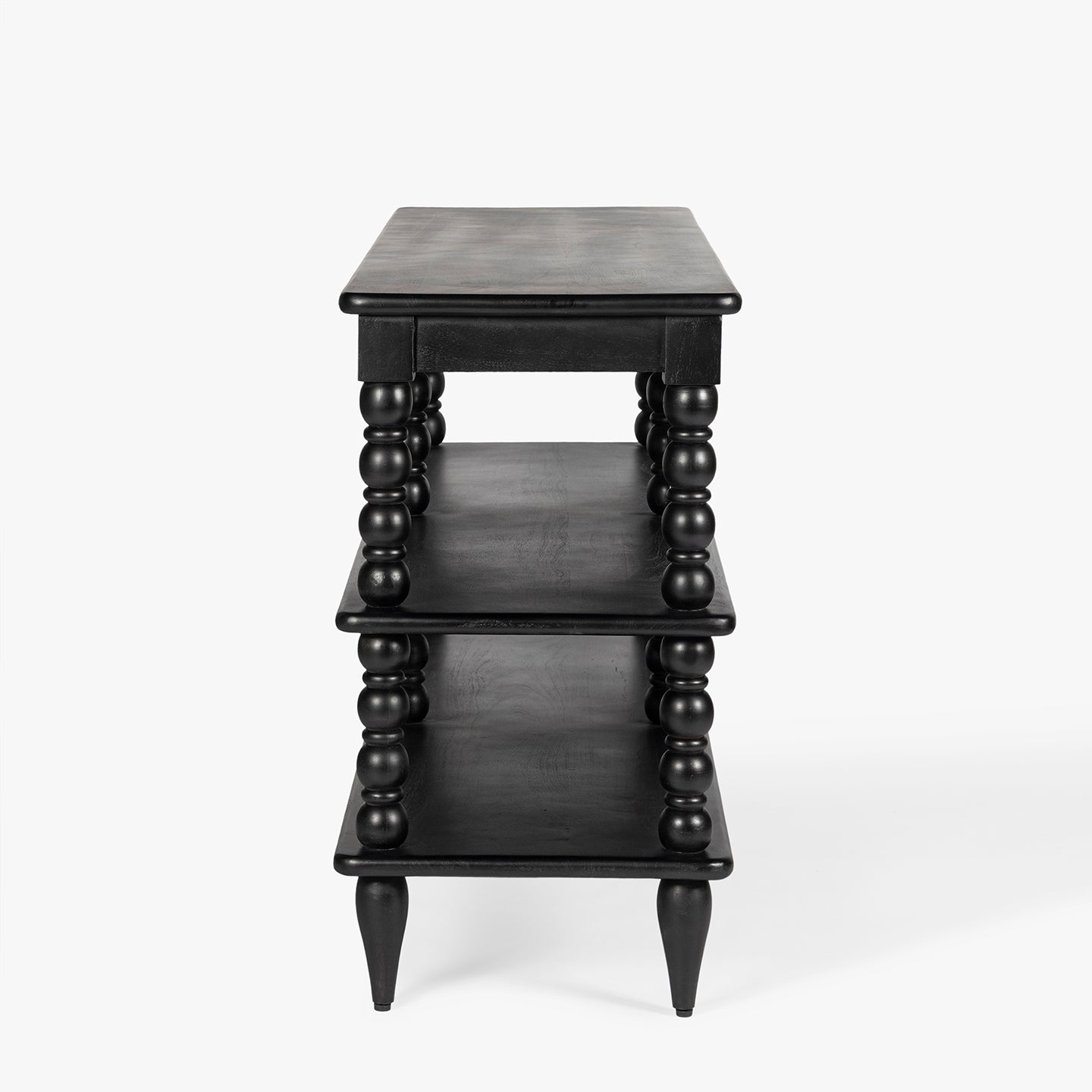Black three-tiered bookcase on a white background