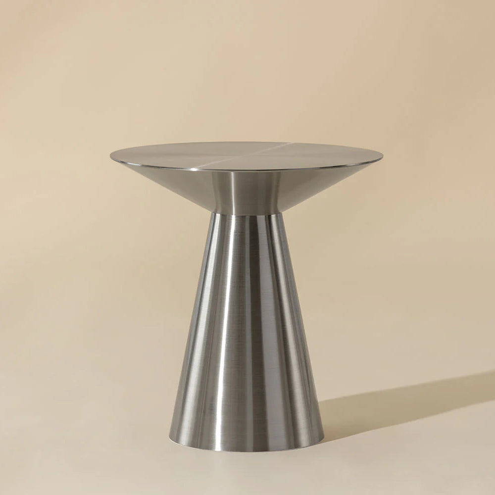 Metallic side table on a beige background
