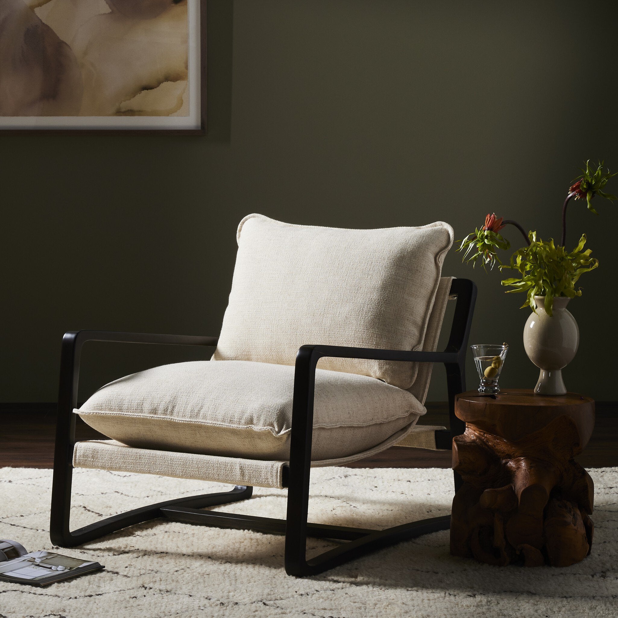 Modern chair with a wooden side table and decorative elements in a room setting.