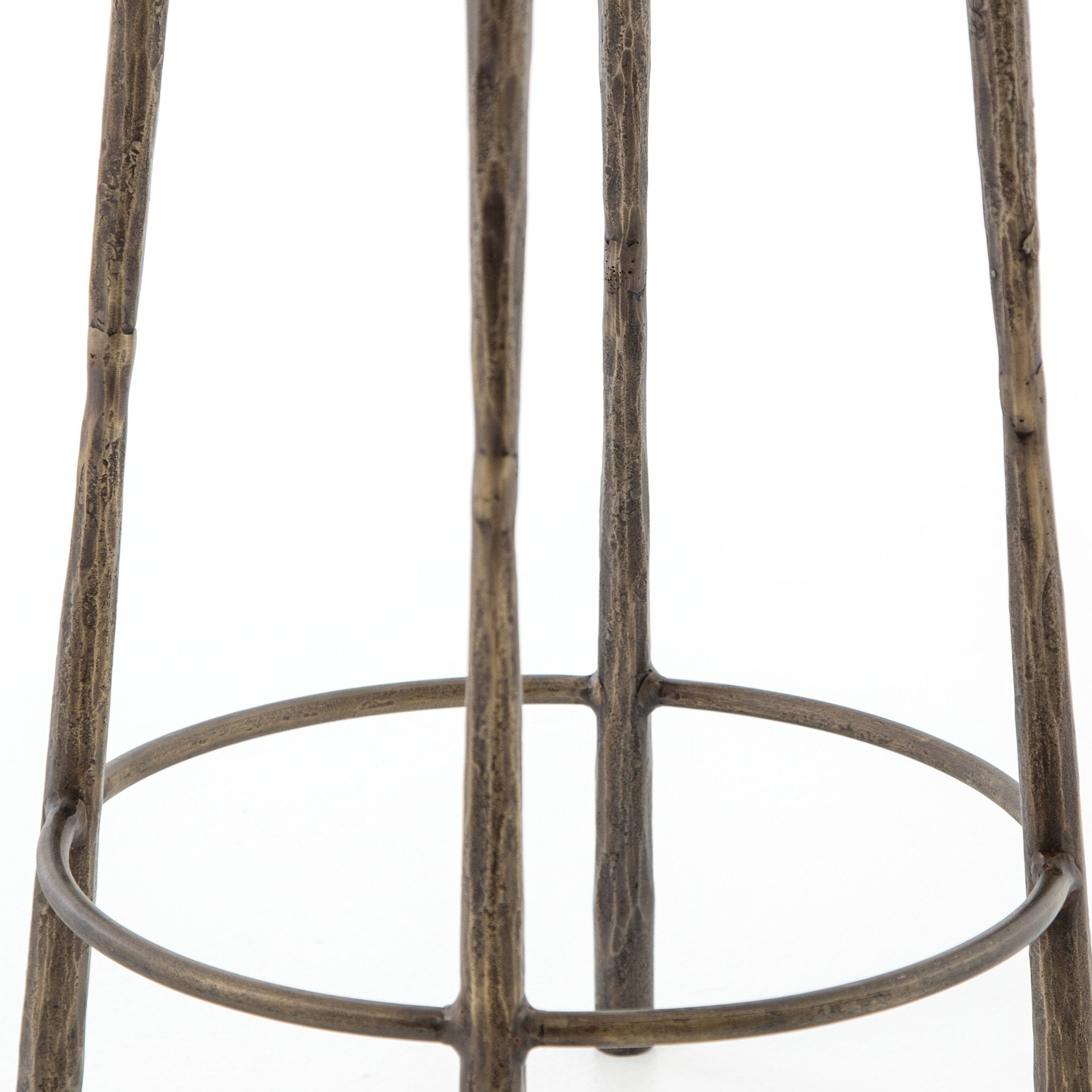 Close-up of a hammered iron bar stool with a white background