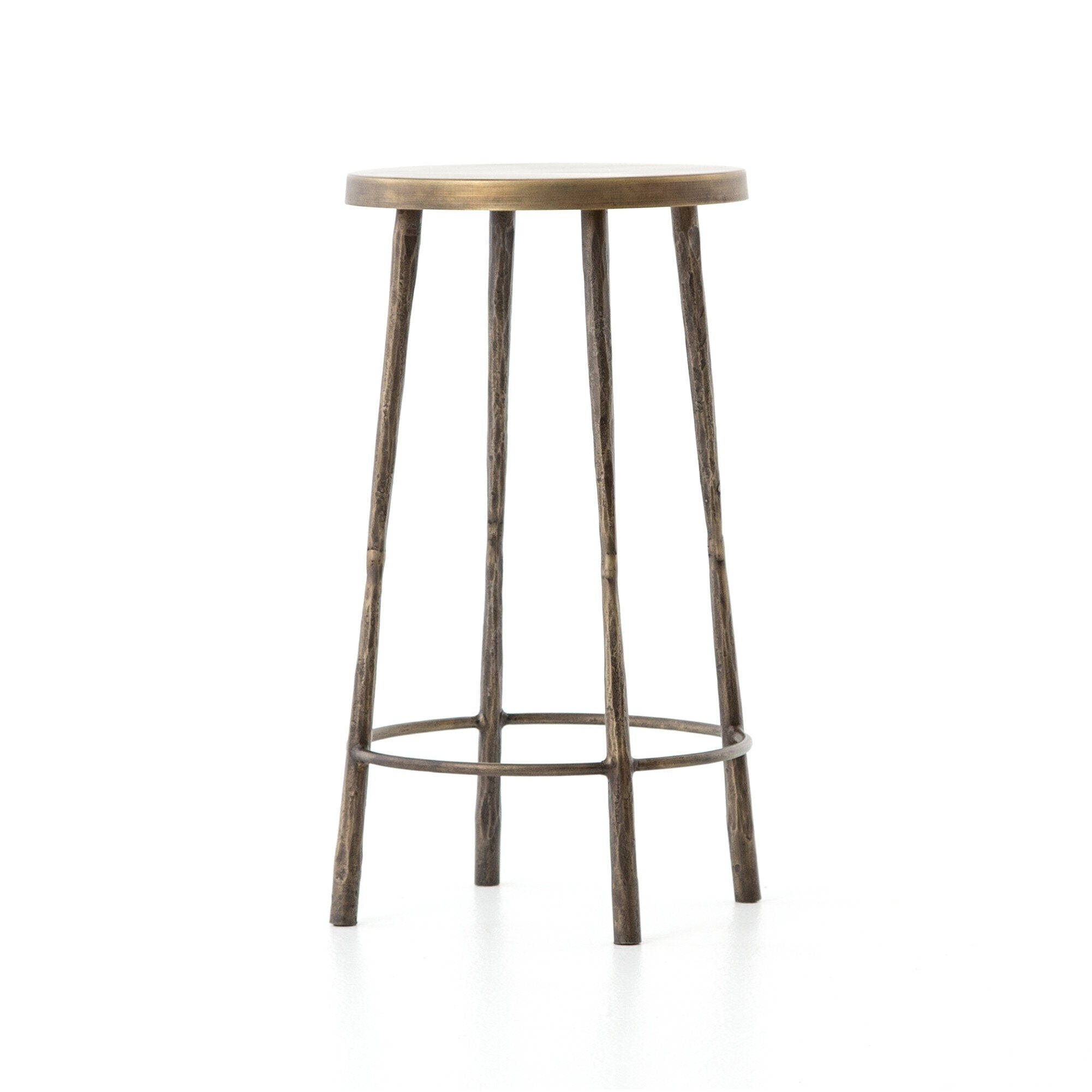Brass counter stool with hammered metal base on a white background