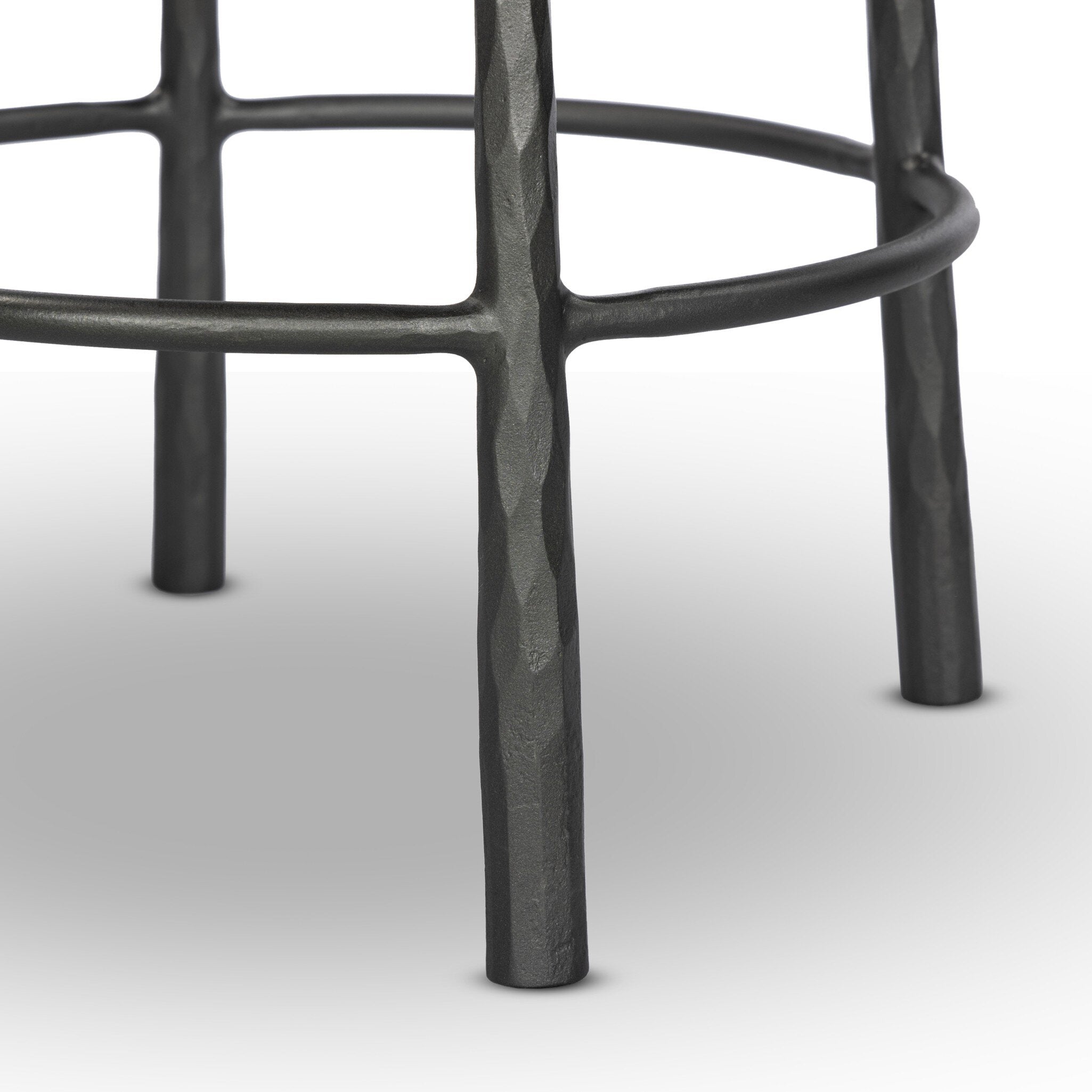 Close-up of a black metal stool base on a white background