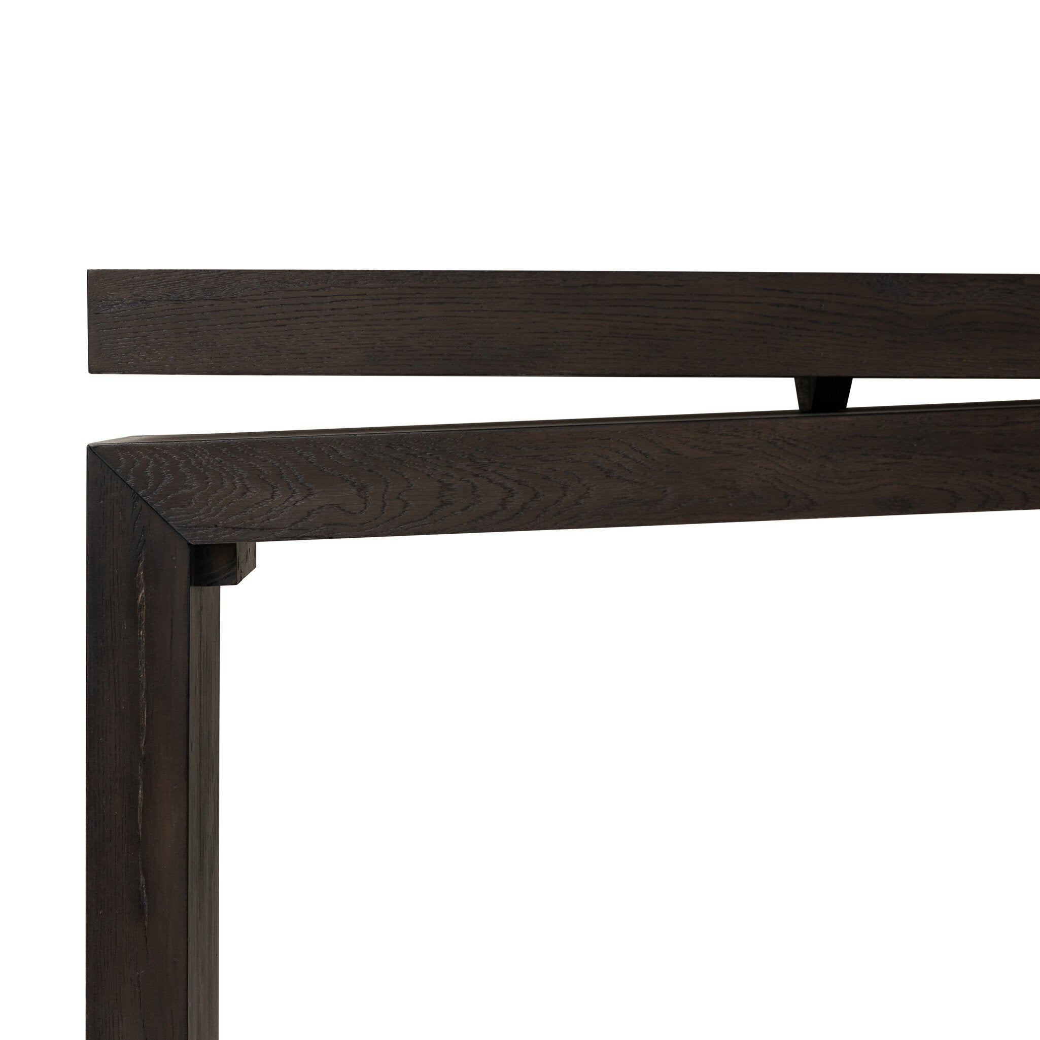Close-up of a dark wooden headboard frame on a white background