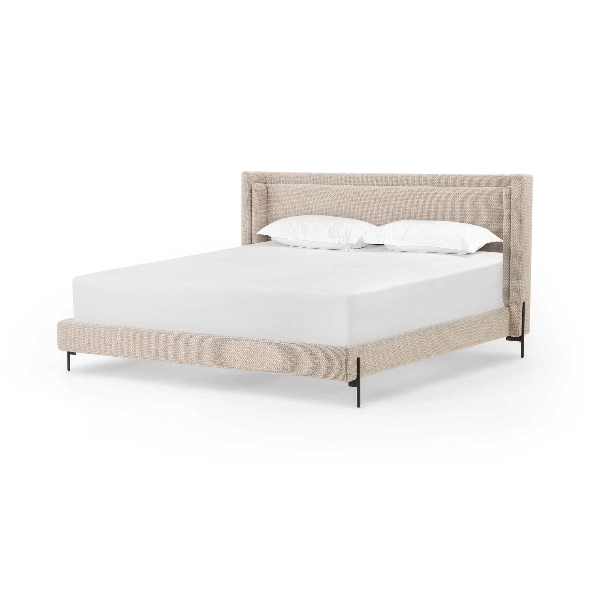 Beige upholstered bed with white bedding on a white background