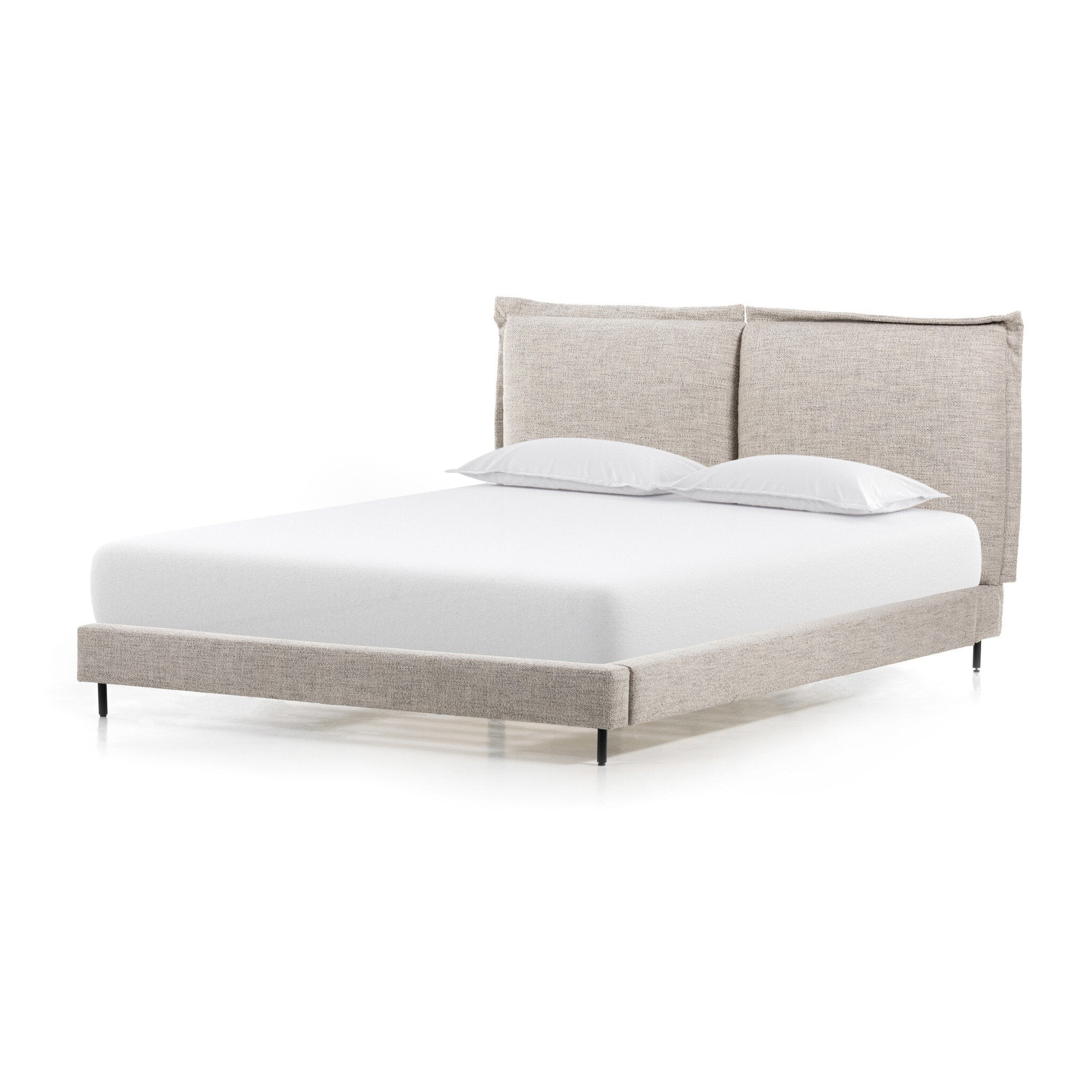 Beige upholstered bed with white bedding on a white background