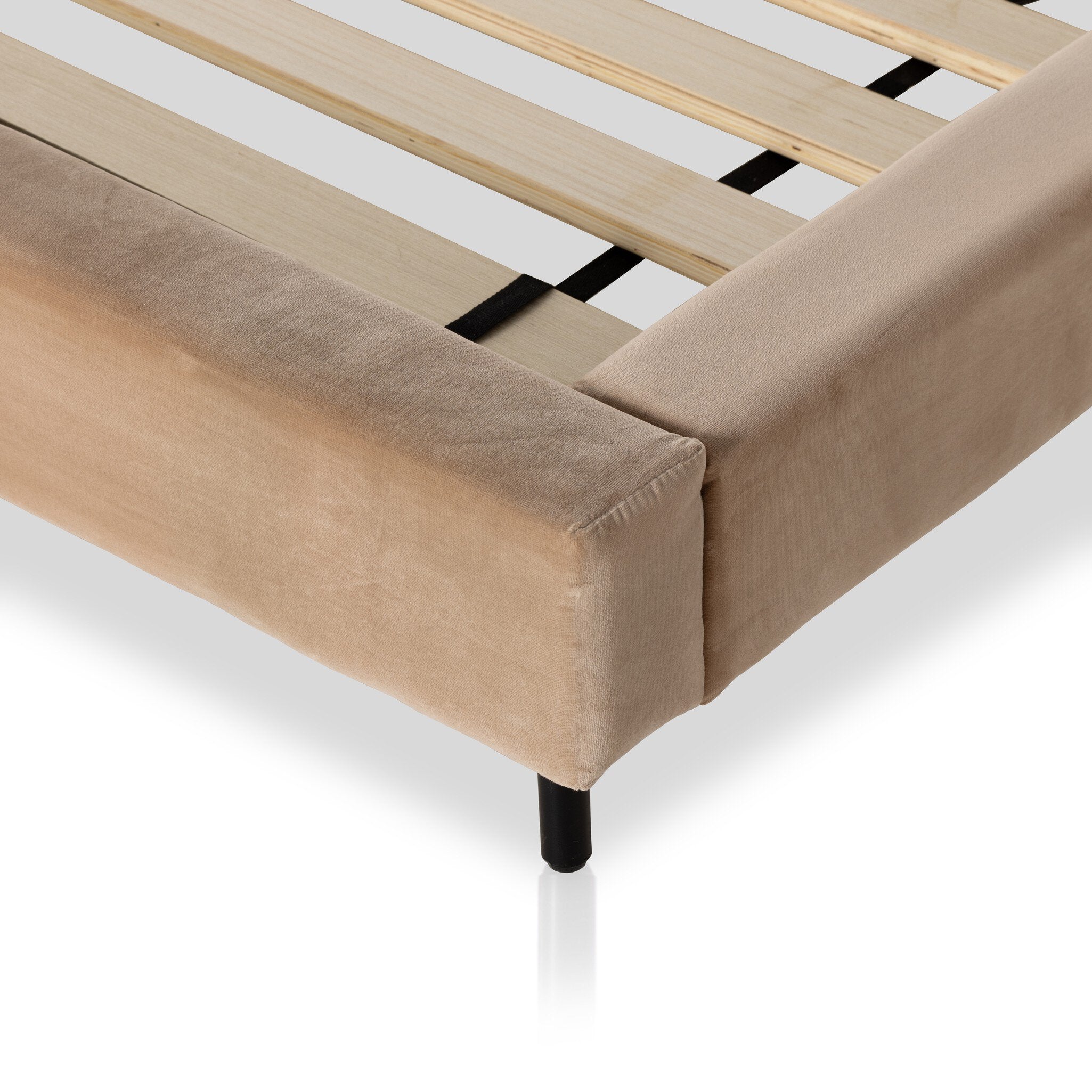 Tan velvet bed frame with wooden slats on a white background