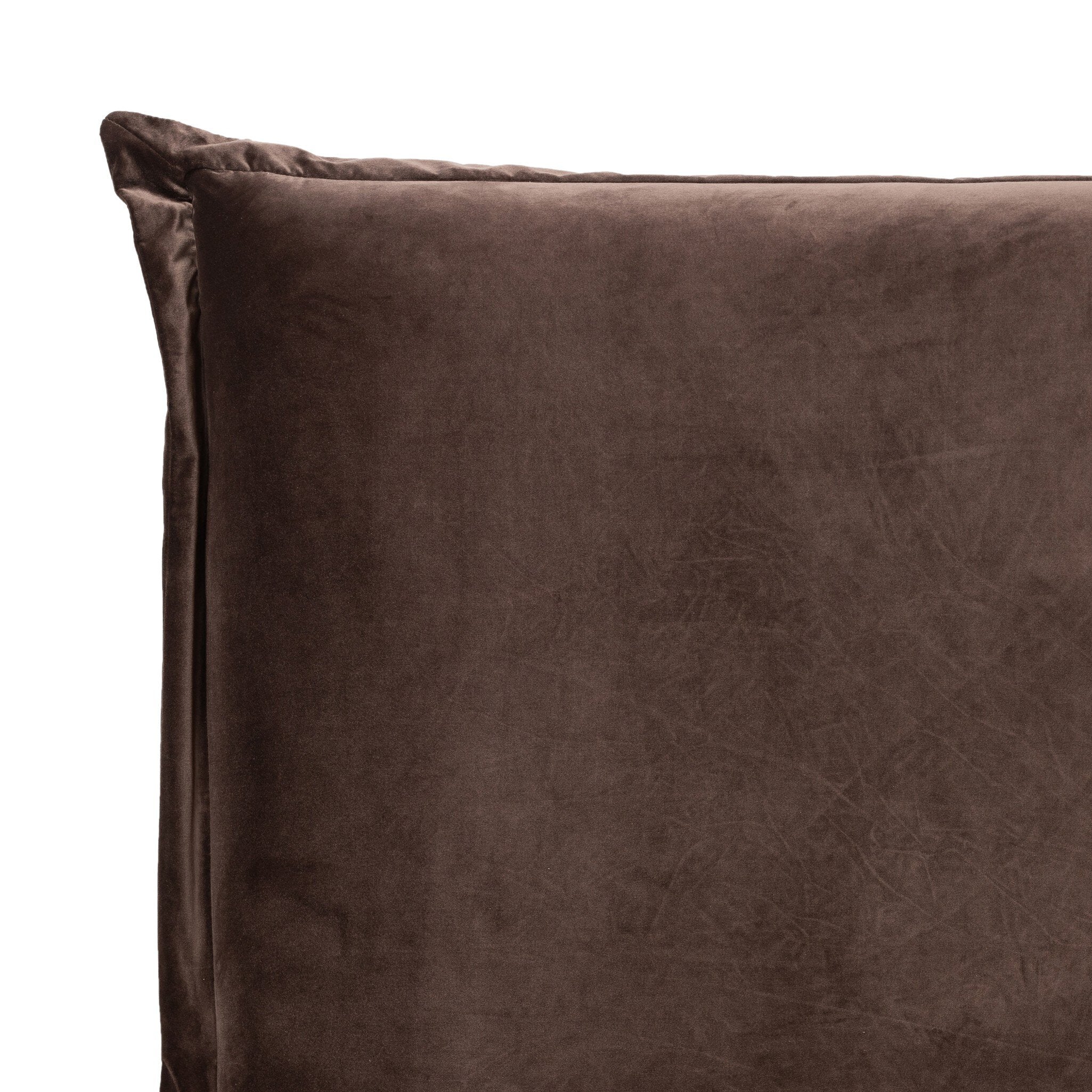 Close-up of a brown velvet upholstered headboard on a white background