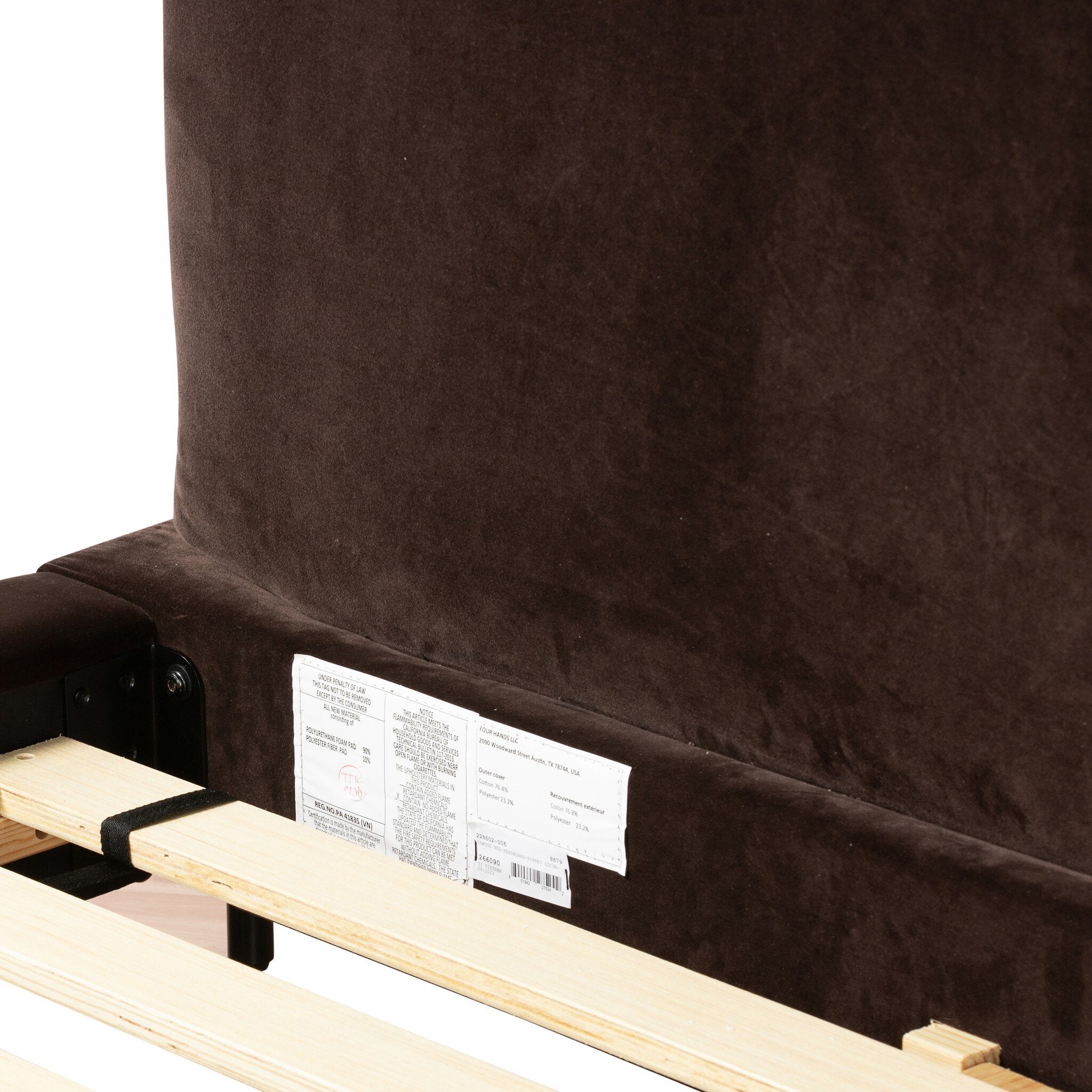 Brown upholstered headboard with a label on a white background