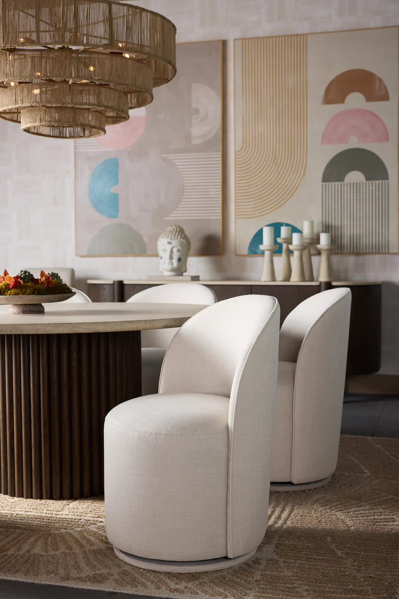 Modern dining room with white chairs, a wooden table, and abstract wall art.