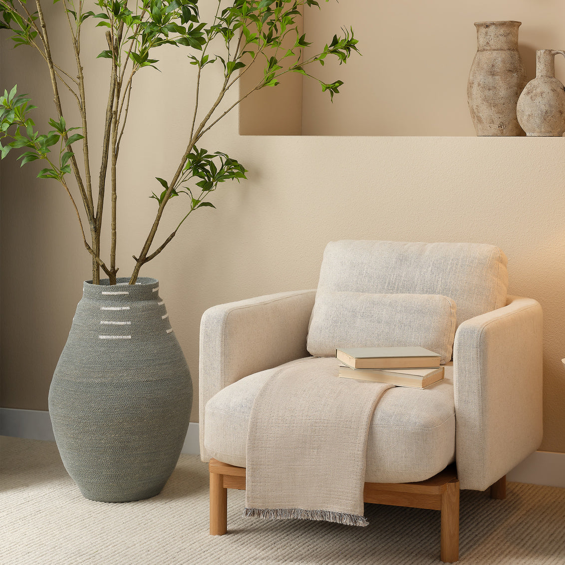 Textured woven basket with white accents on a white background