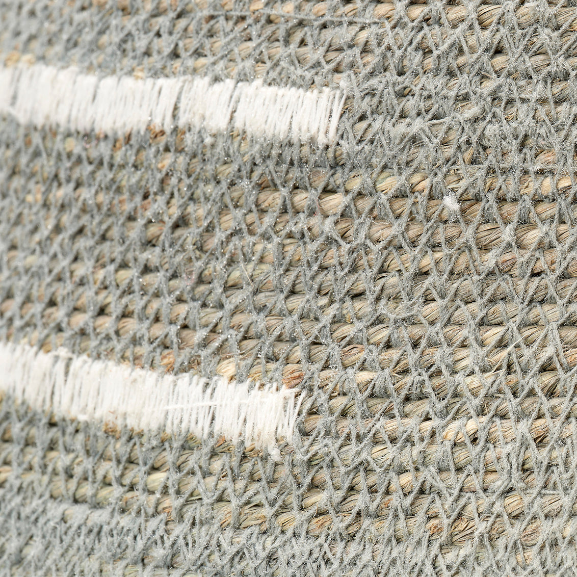 Textured woven basket with white accents on a white background