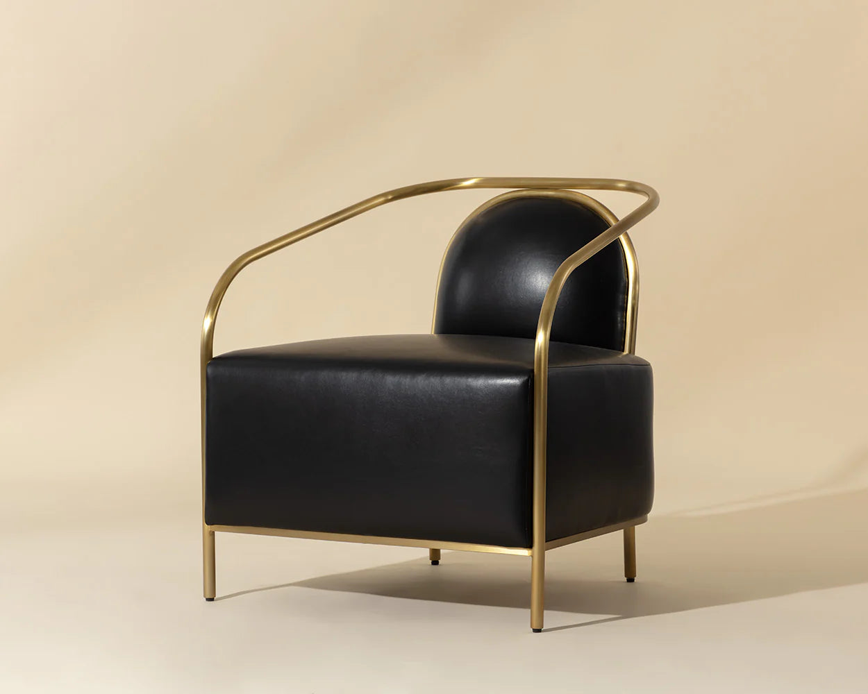 Black leather armchair with gold frame on a beige background