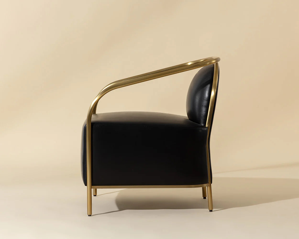 Black armchair with gold frame on a beige background