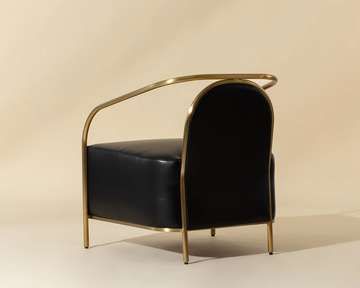 Black chair with gold frame on a beige background
