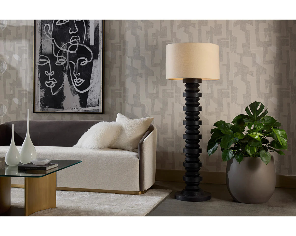 Living room with a sofa, coffee table, floor lamp, and decorative items.