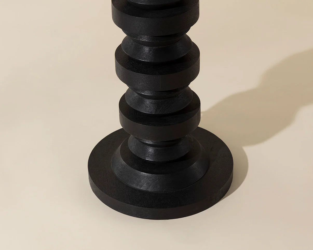 Black candlestick lamp on a beige background