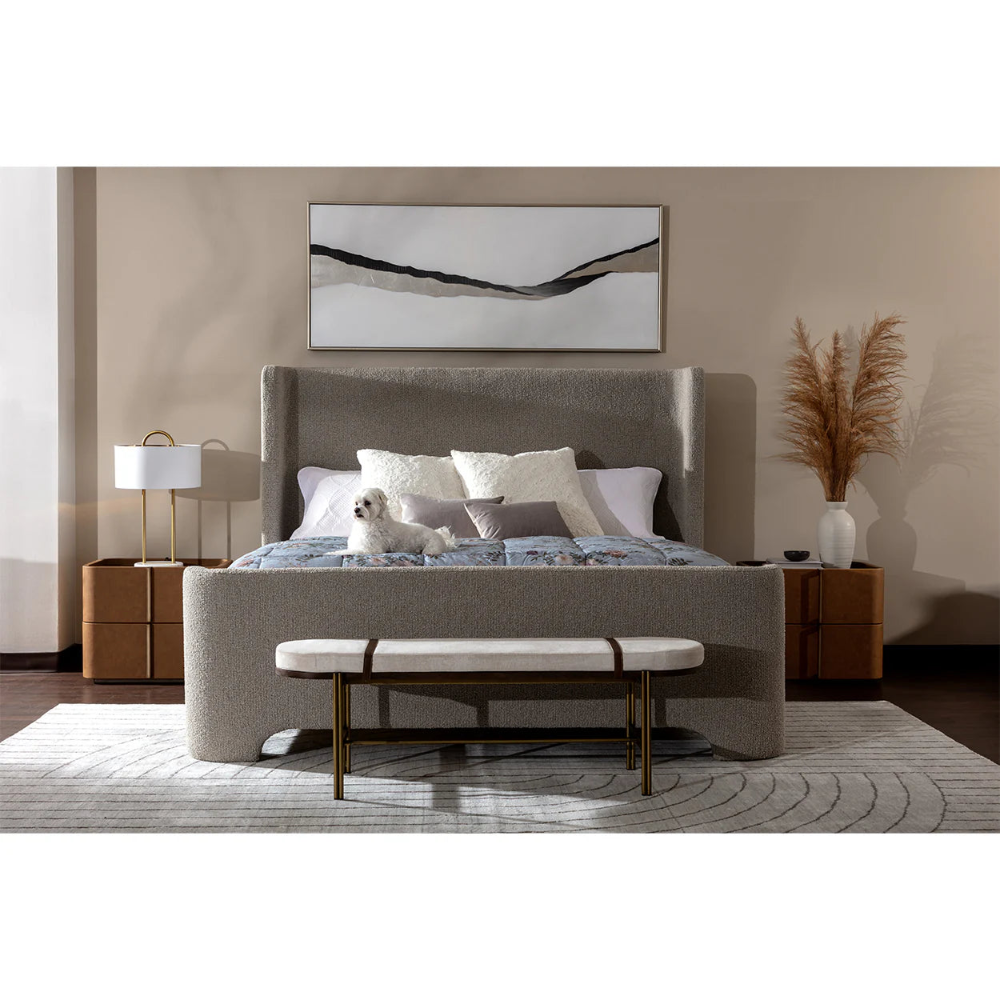 Modern bedroom with a grey rug, grey upholstered bed, and brown leather nightstands