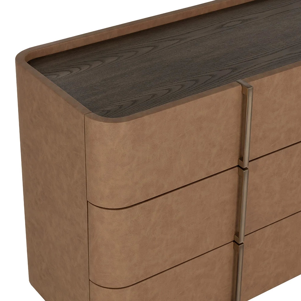 Close-up of a modern dresser with curved edges, a dark wood grain top, and three drawers with slim vertical metal handles on a white background.
