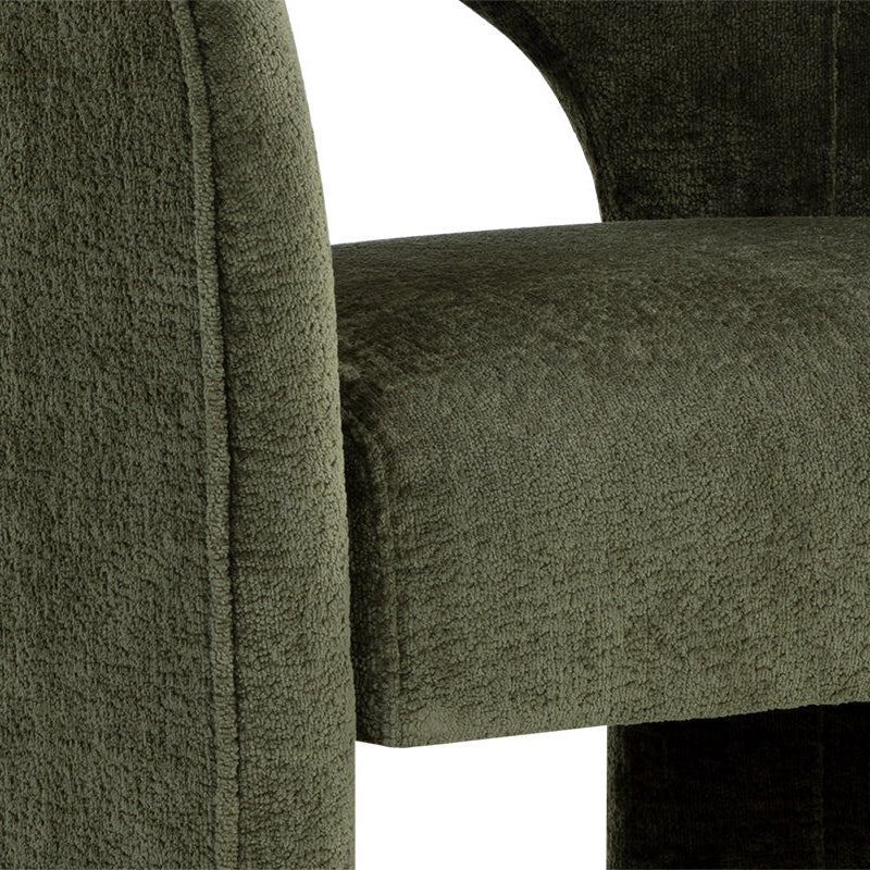 Close-up of a green upholstered chair with a textured fabric.