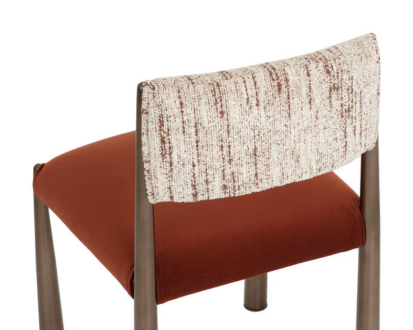Chair with a patterned backrest and red seat on a white background
