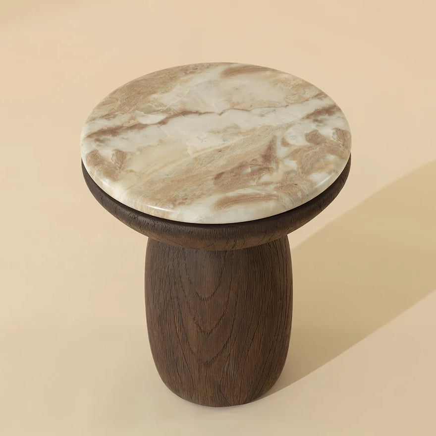 A mushroom-shaped end table with a round marble-patterned lid and a dark brown wooden base, set against a solid beige background.