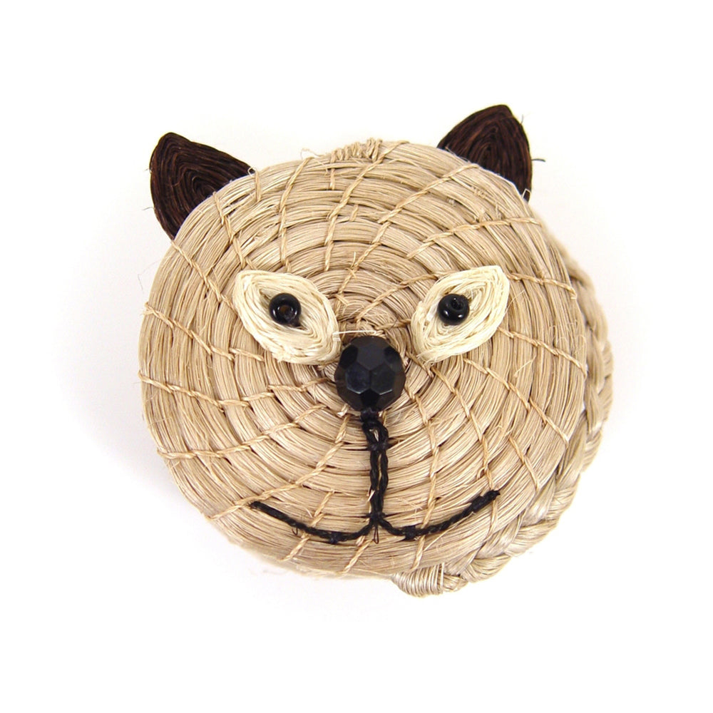 Woven cat-shaped basket with black eyes and mouth on a white background