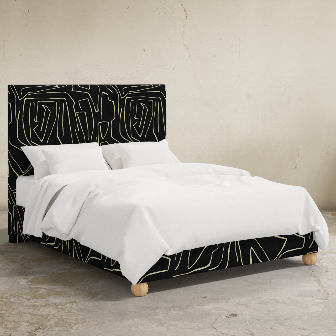 Bed with black and white abstract headboard and bedding on a neutral background