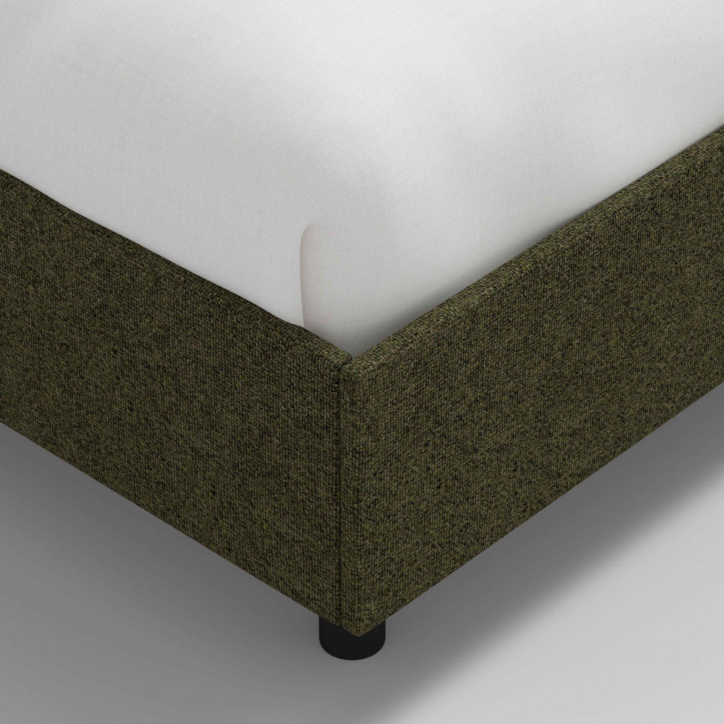 Green upholstered bed with white mattress and pillows on a white background