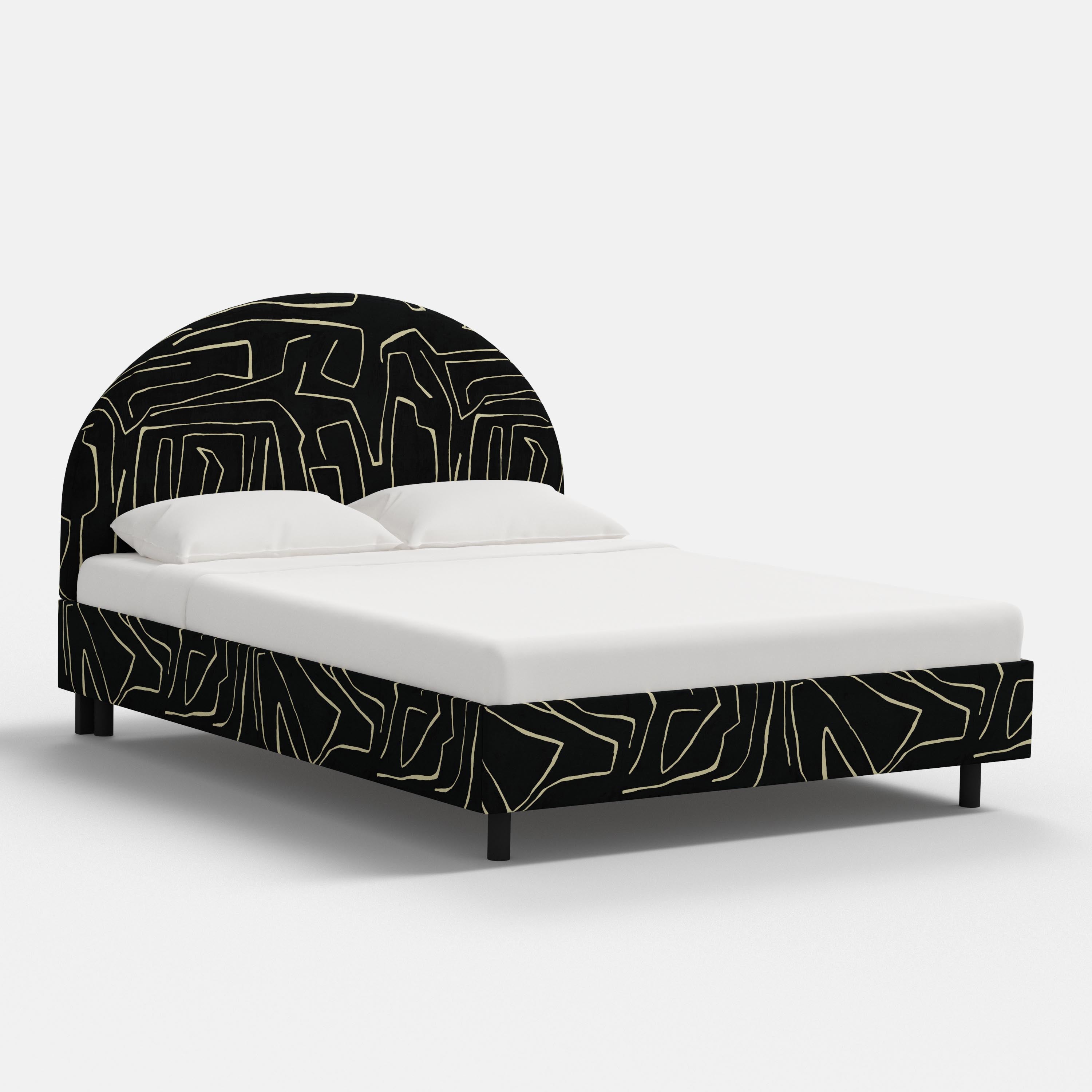Bed with black geometric headboard and footboard on a white background