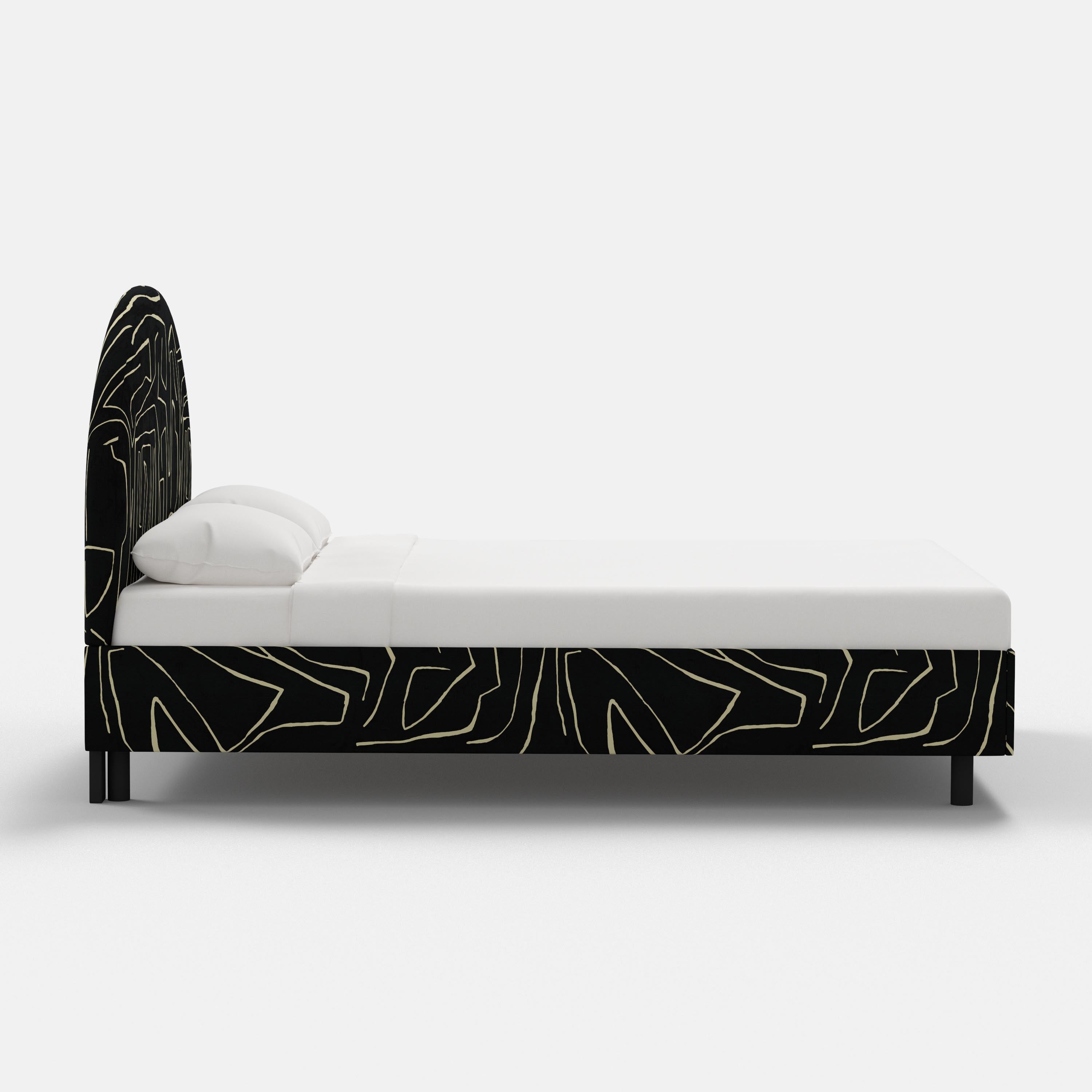 Bed with black geometric headboard and footboard on a white background
