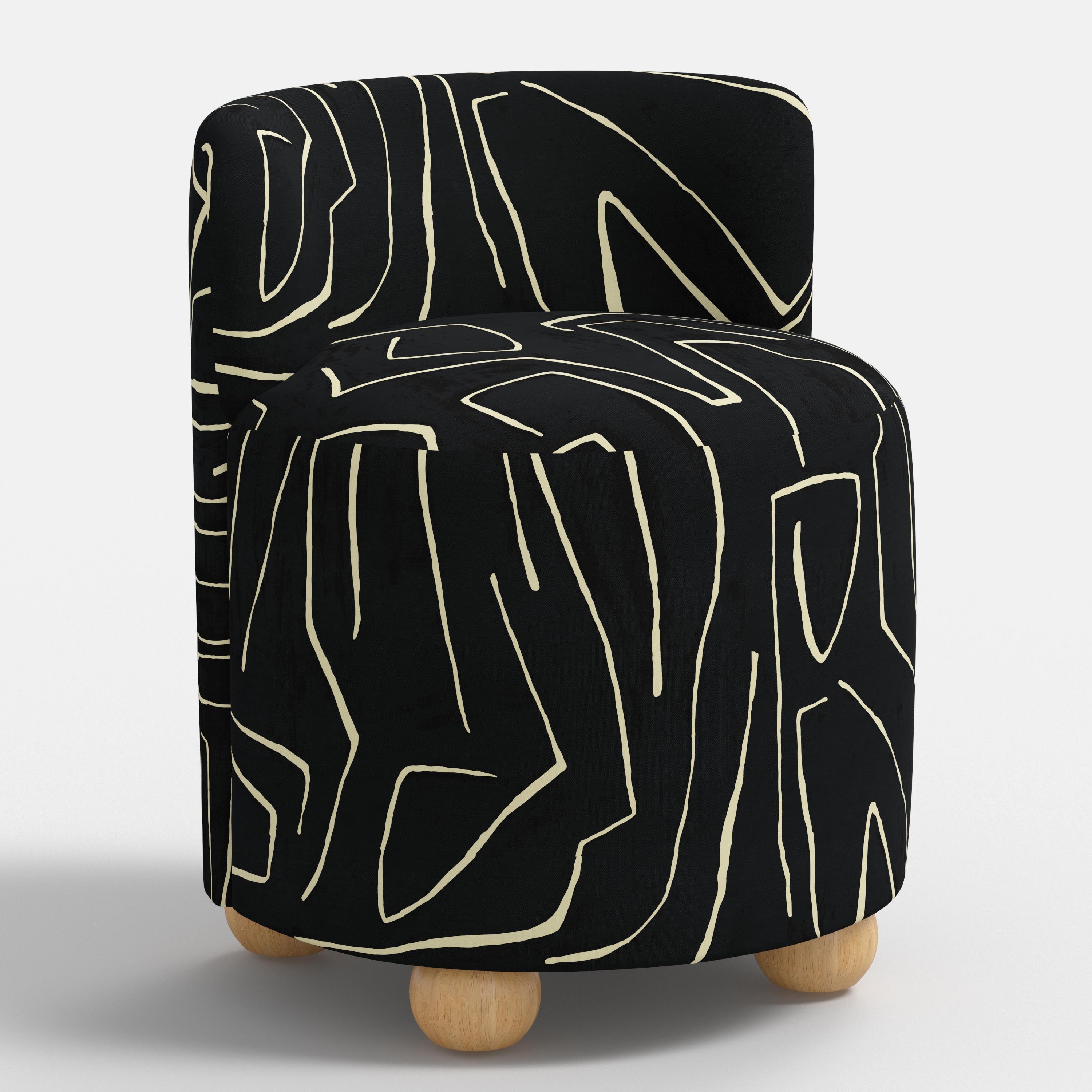 Black and white patterned seat with wooden legs on a white background