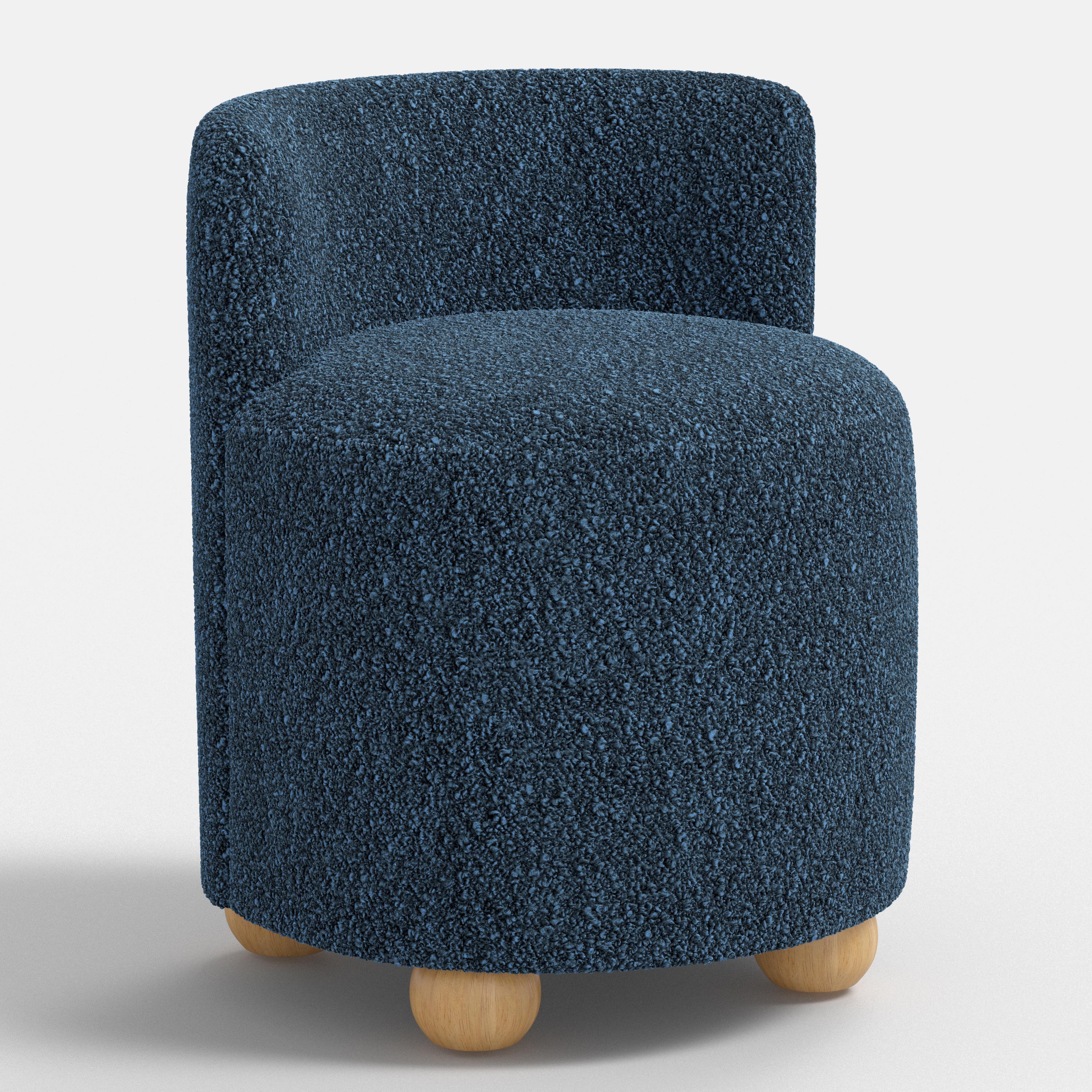 Blue textured armchair with wooden legs on a white background