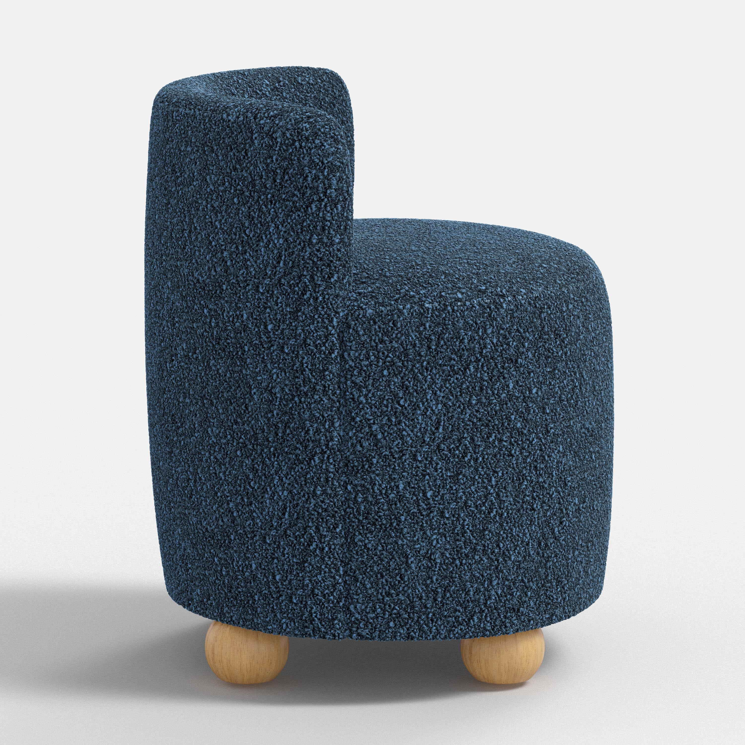 Blue textured armchair with wooden legs on a white background