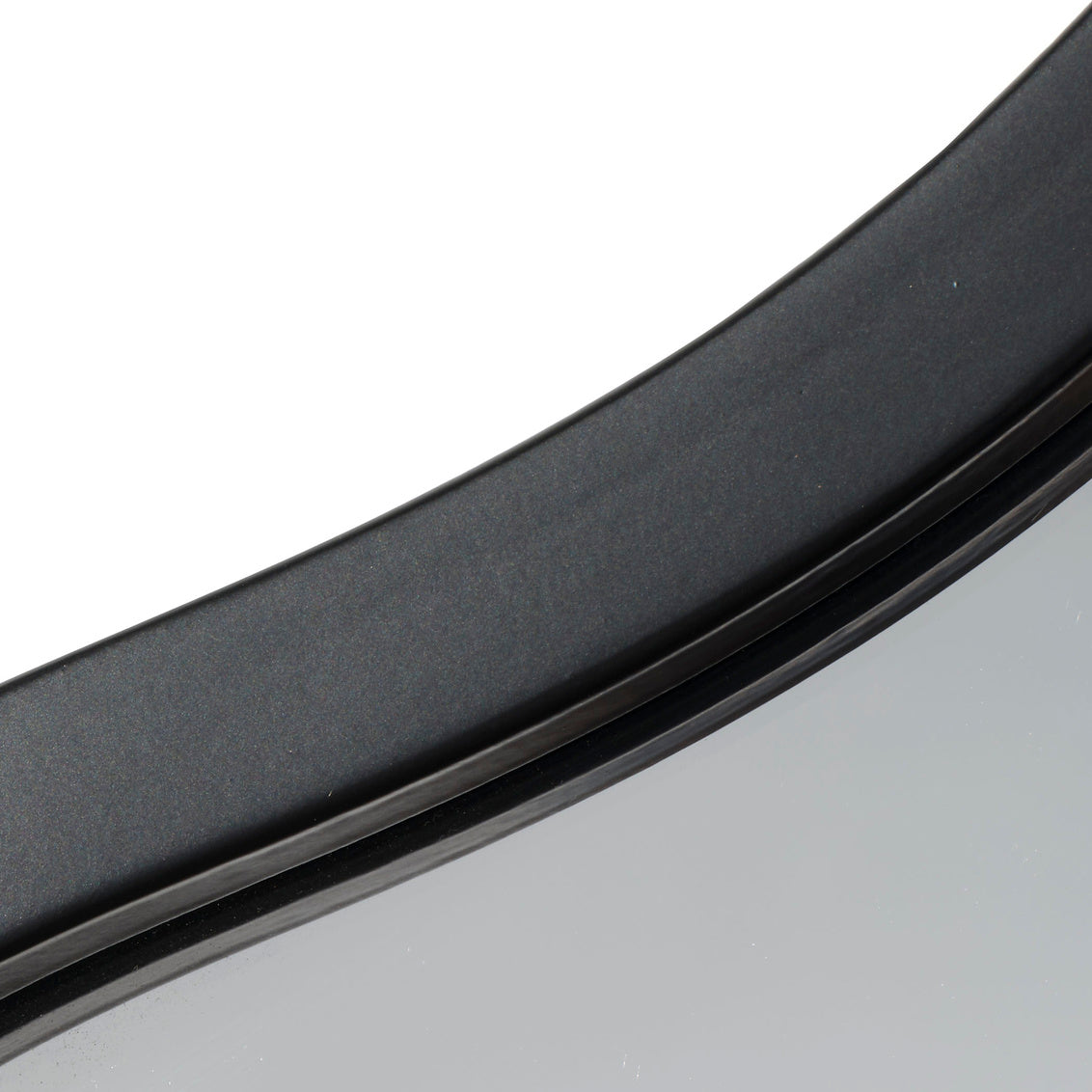 Close-up of a black iron mirror frame on a white background