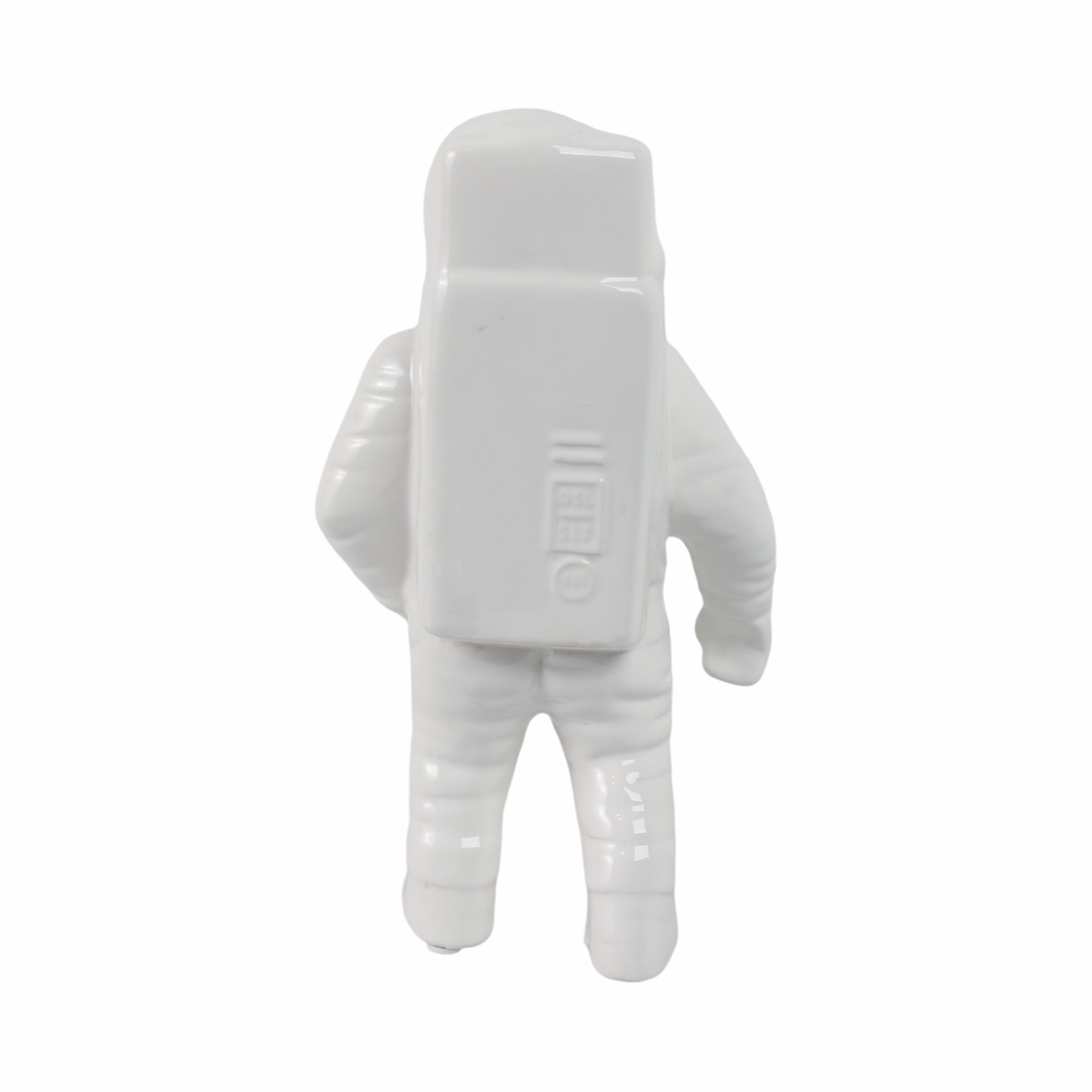 White astronaut figurine on a white background