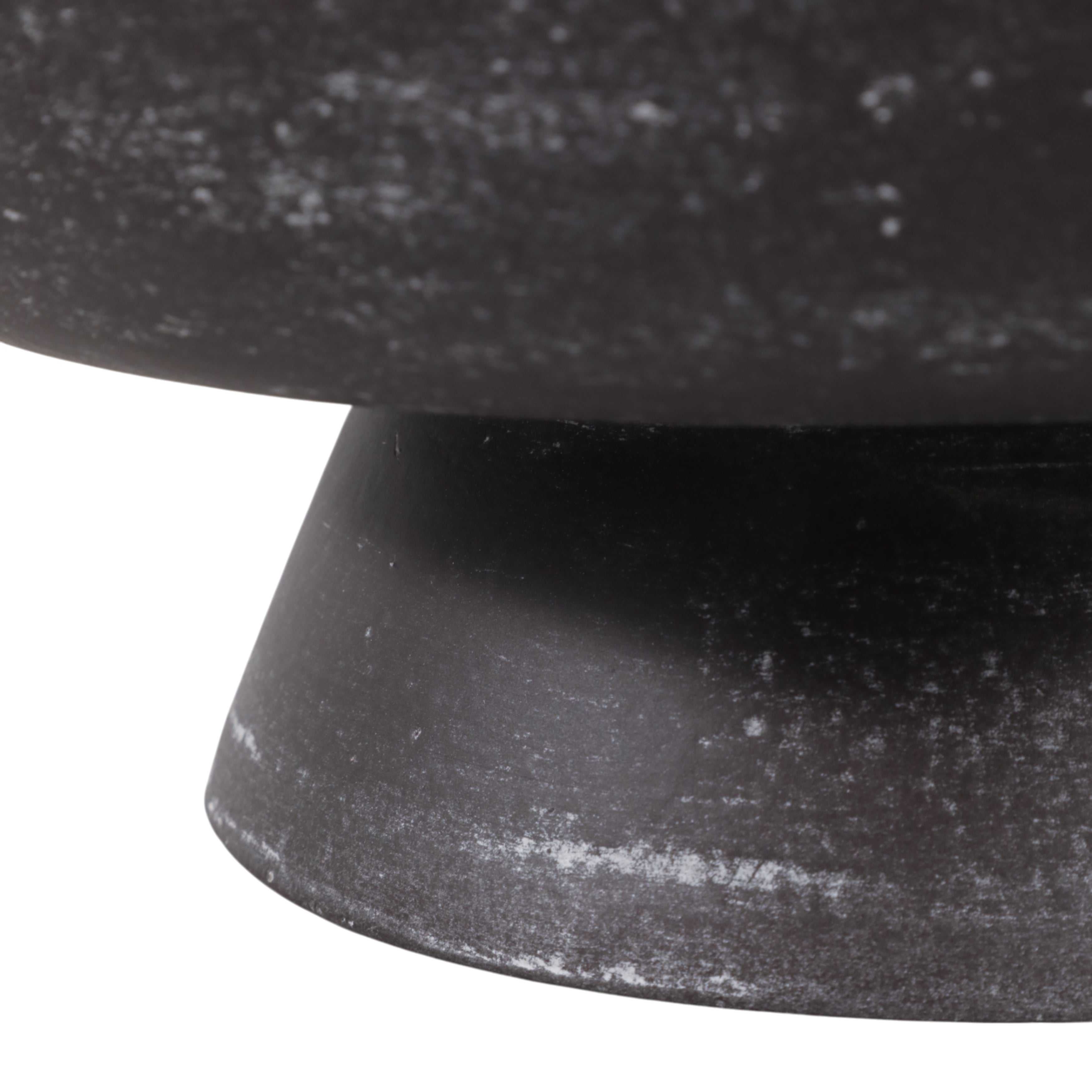 Close-up of a black stone pedestal on a white background