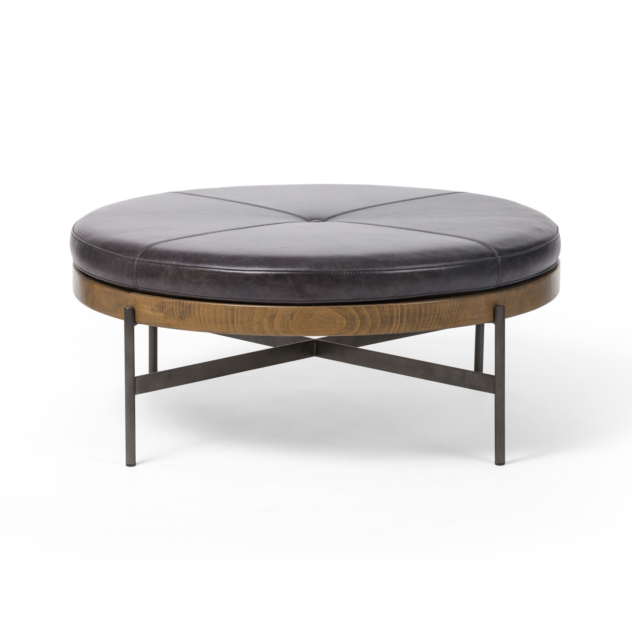 Round ottoman with dark leather top and wooden base on a white background