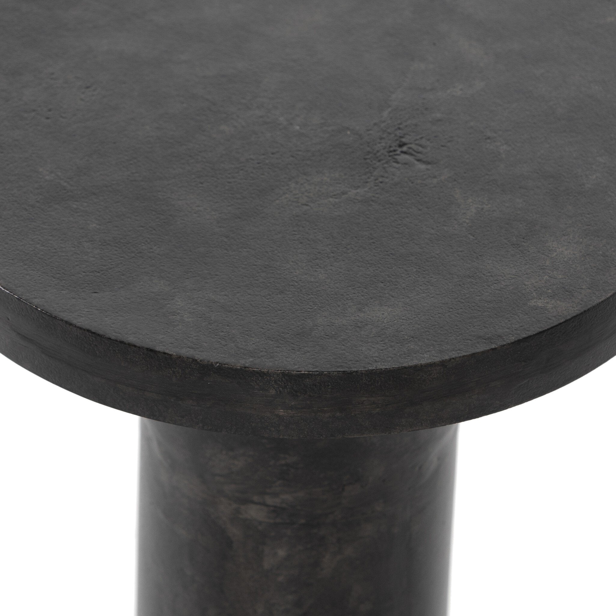 Round black metal table top on a white background