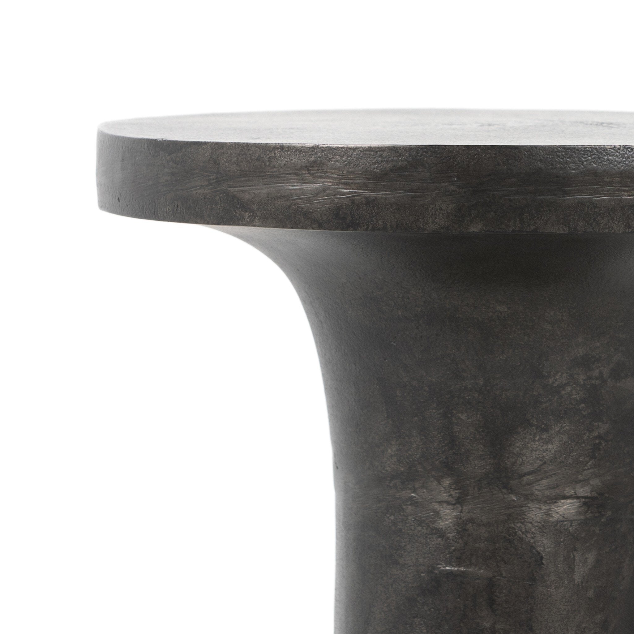 Close-up of a dark stone pedestal end table on a white background